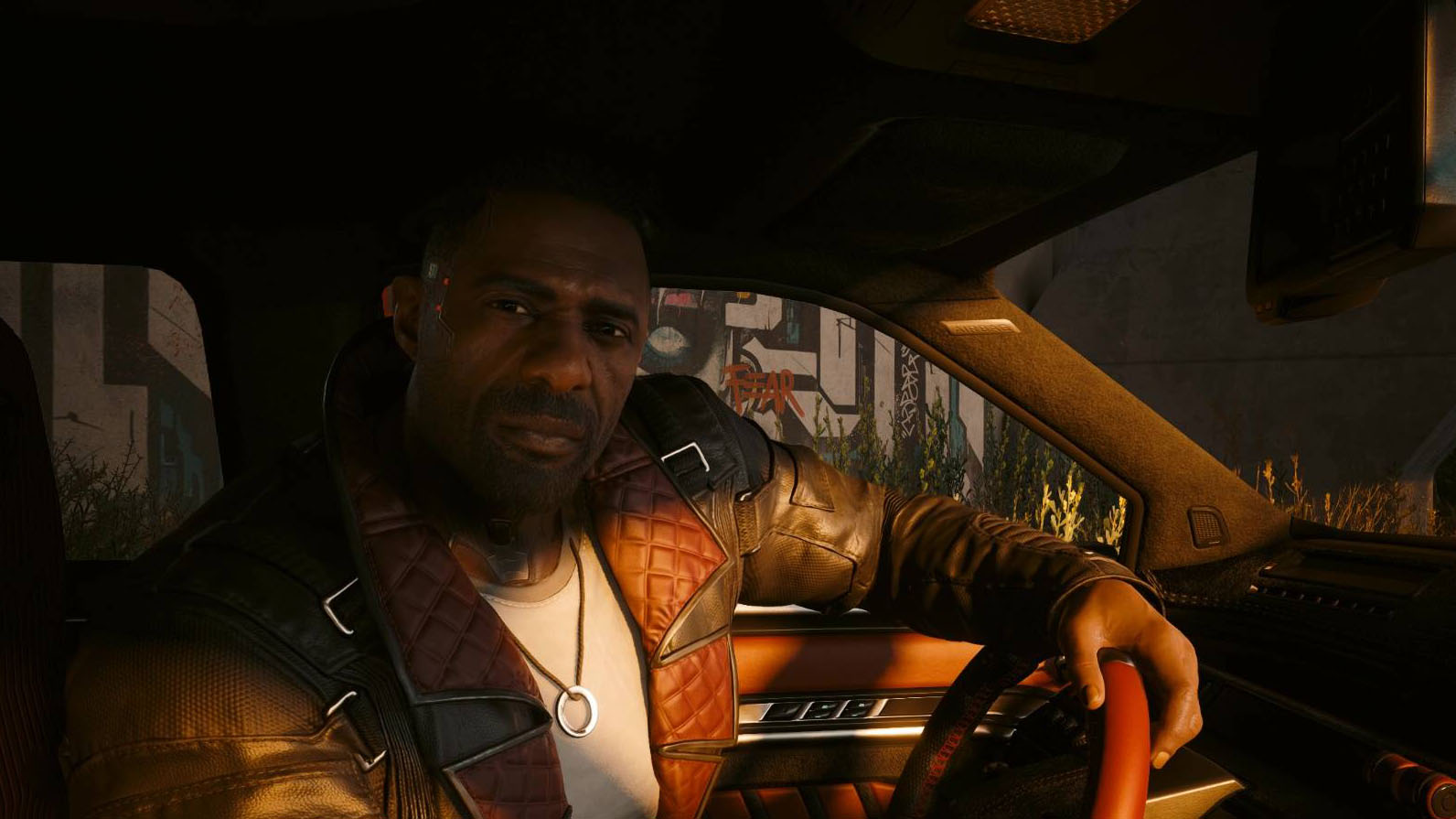 Solomon Reed stares at V while driving a car in Cyberpunk 2077: Phantom Liberty.