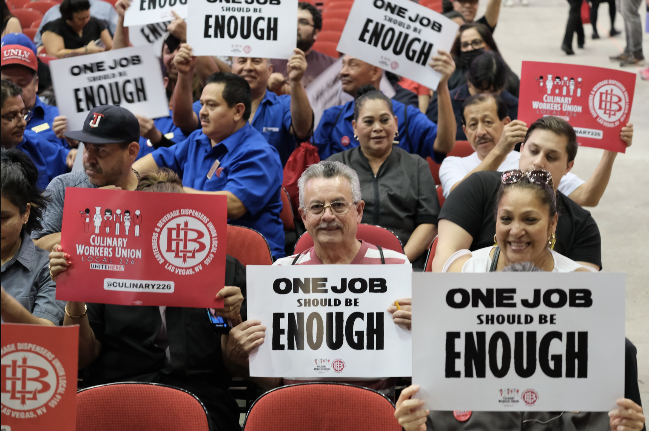 Members of the Las Vegas Culinary Union hold up protest signs.
