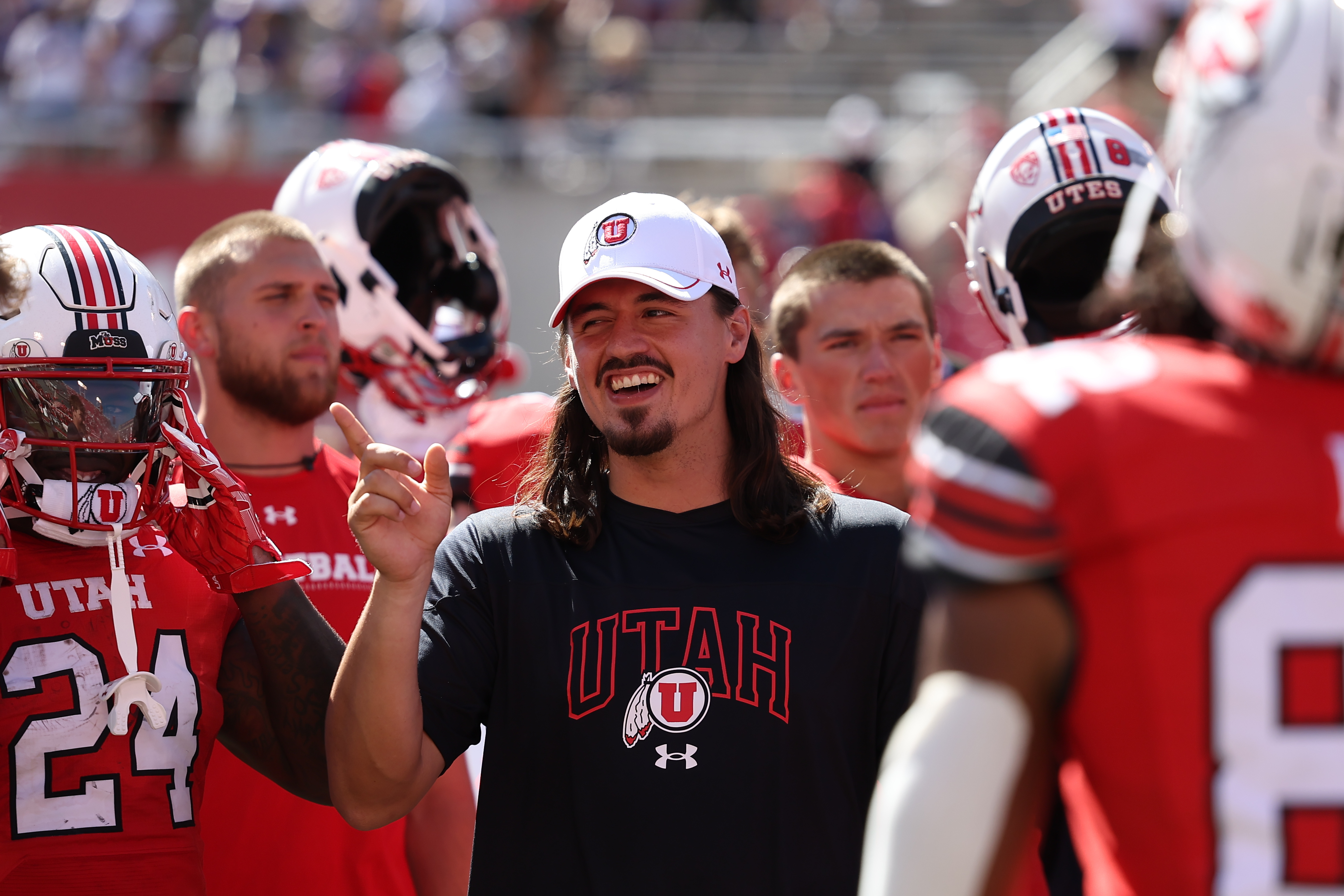 Utah Utes quarterback Cameron Rising celebrates with teammates after defeating the Weber State Wildcats at Rice-Eccles Stadium.