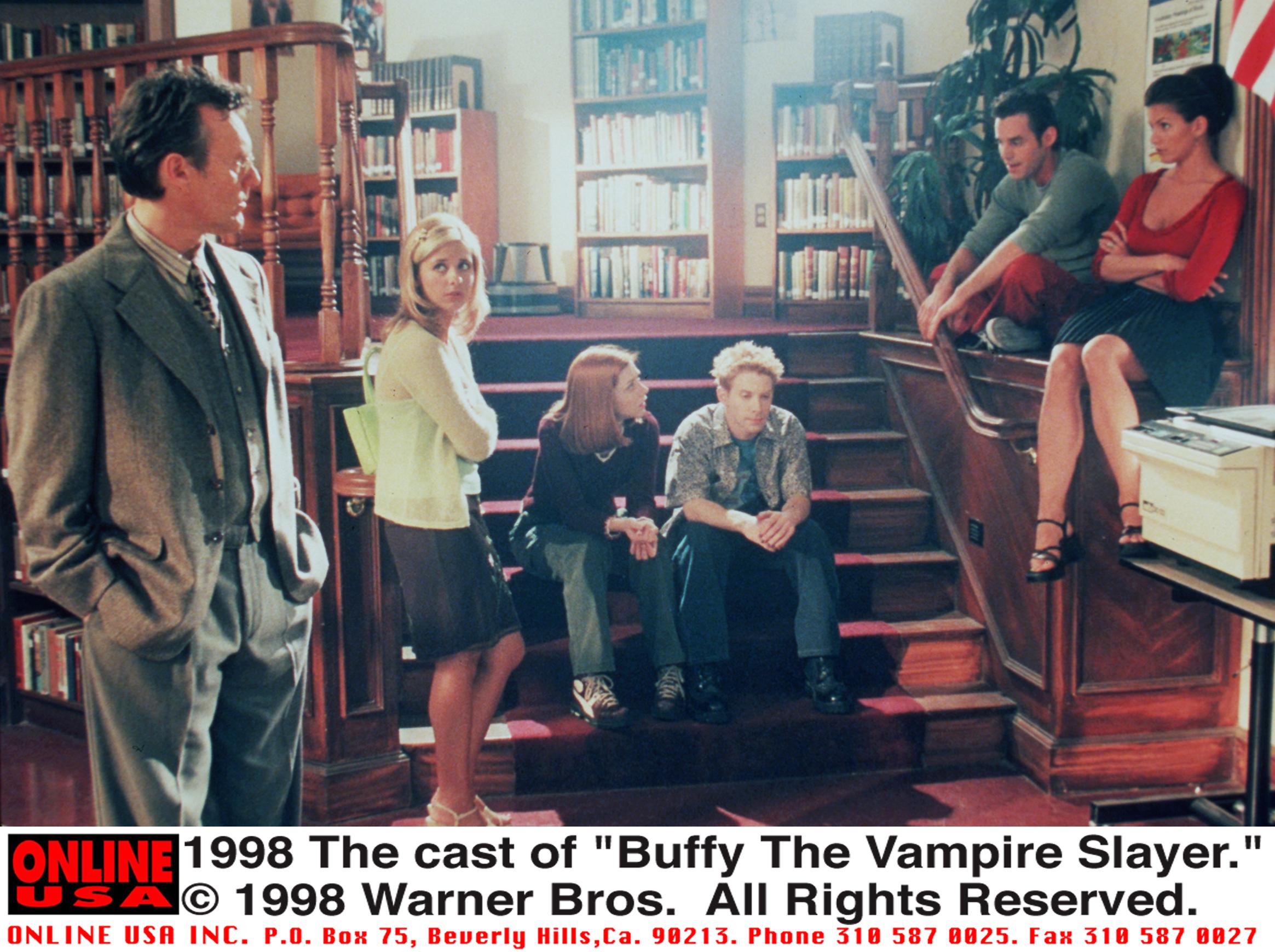 The cast of “Buffy The Vampire Slayer” photographed in a library in the late ’90s, including Anthony Stewart Head, Sarah Michelle Gellar, Alyson Hannigan, Seth Green, Nicholas Brendon, and Charisma Carpenter