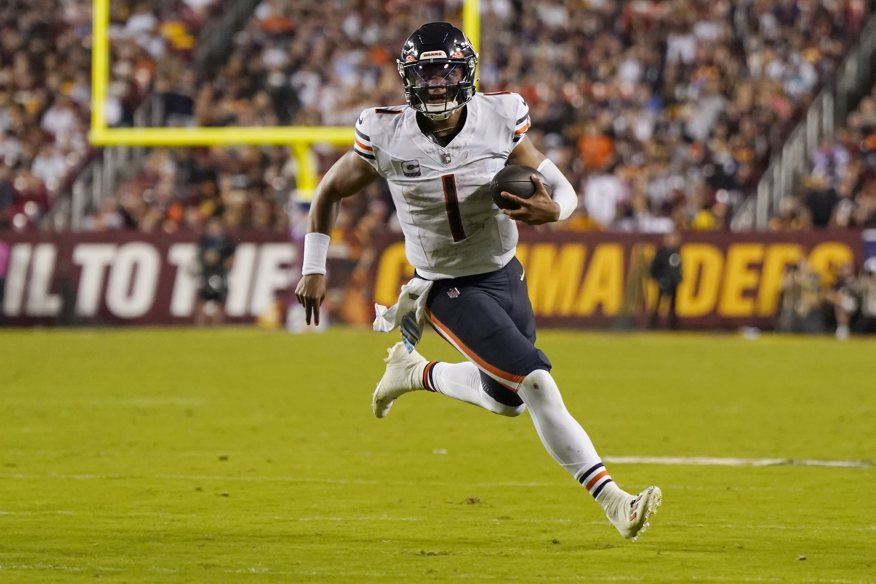 Justin Fields #1 of the Chicago Bears runs with the ball against the Washington Commanders during the second quarter at FedExField on October 05, 2023 in Landover, Maryland.