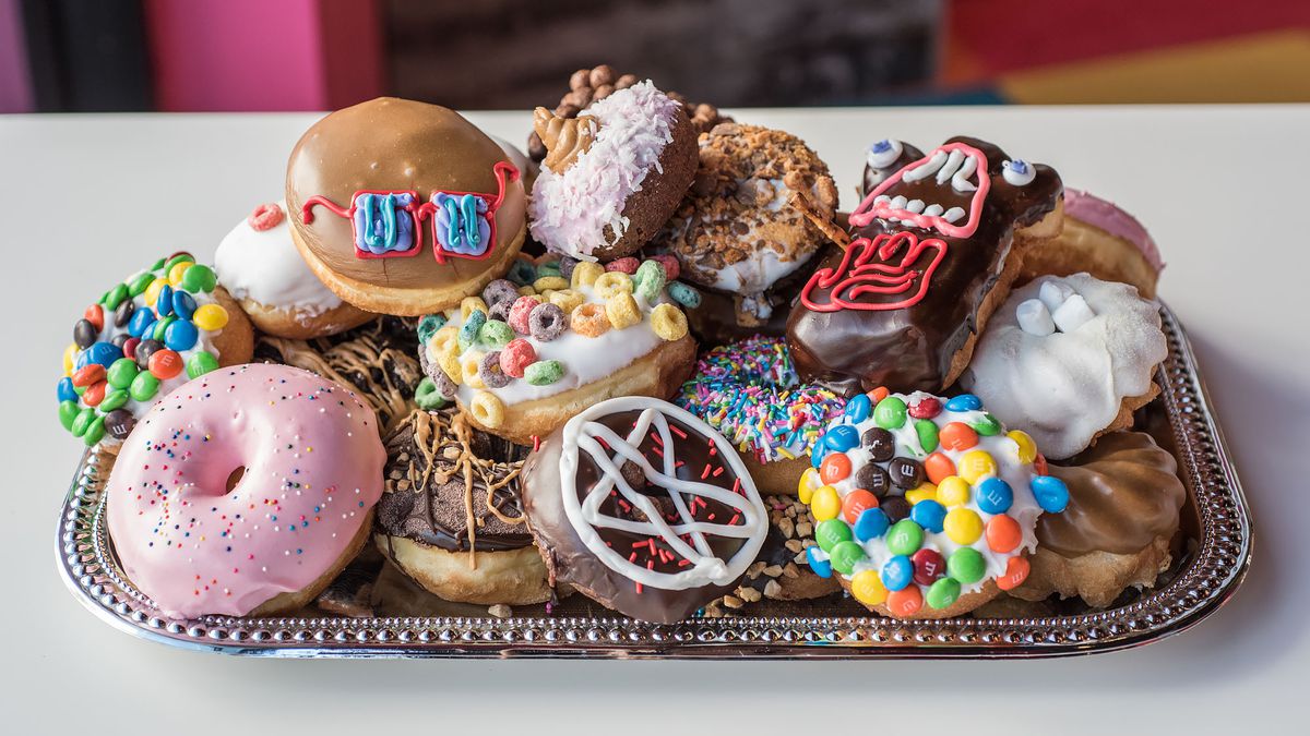 A platter of elaborately decorated doughnuts.