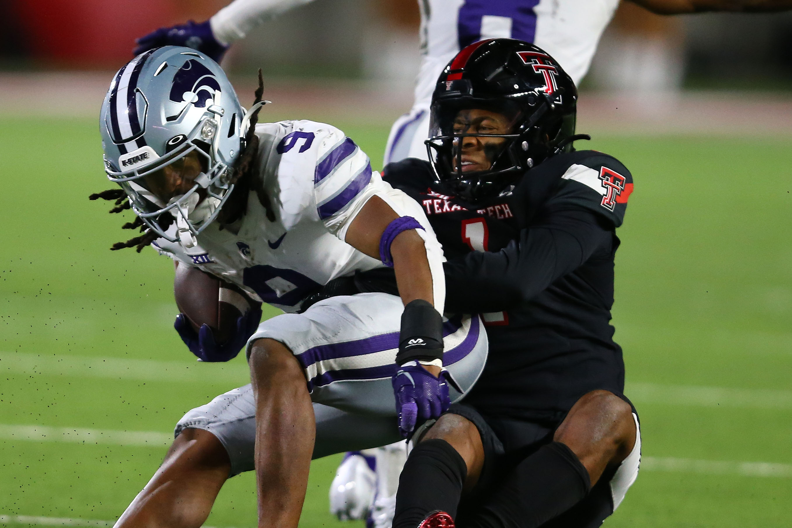 Kansas State Wildcats running back Treshaun Ward (9) is tackled by Texas Tech Red Raiders safety Dadrioin Taylor-Demerson (1) in the second half at Jones AT&amp;T Stadium and Cody Campbell Field.