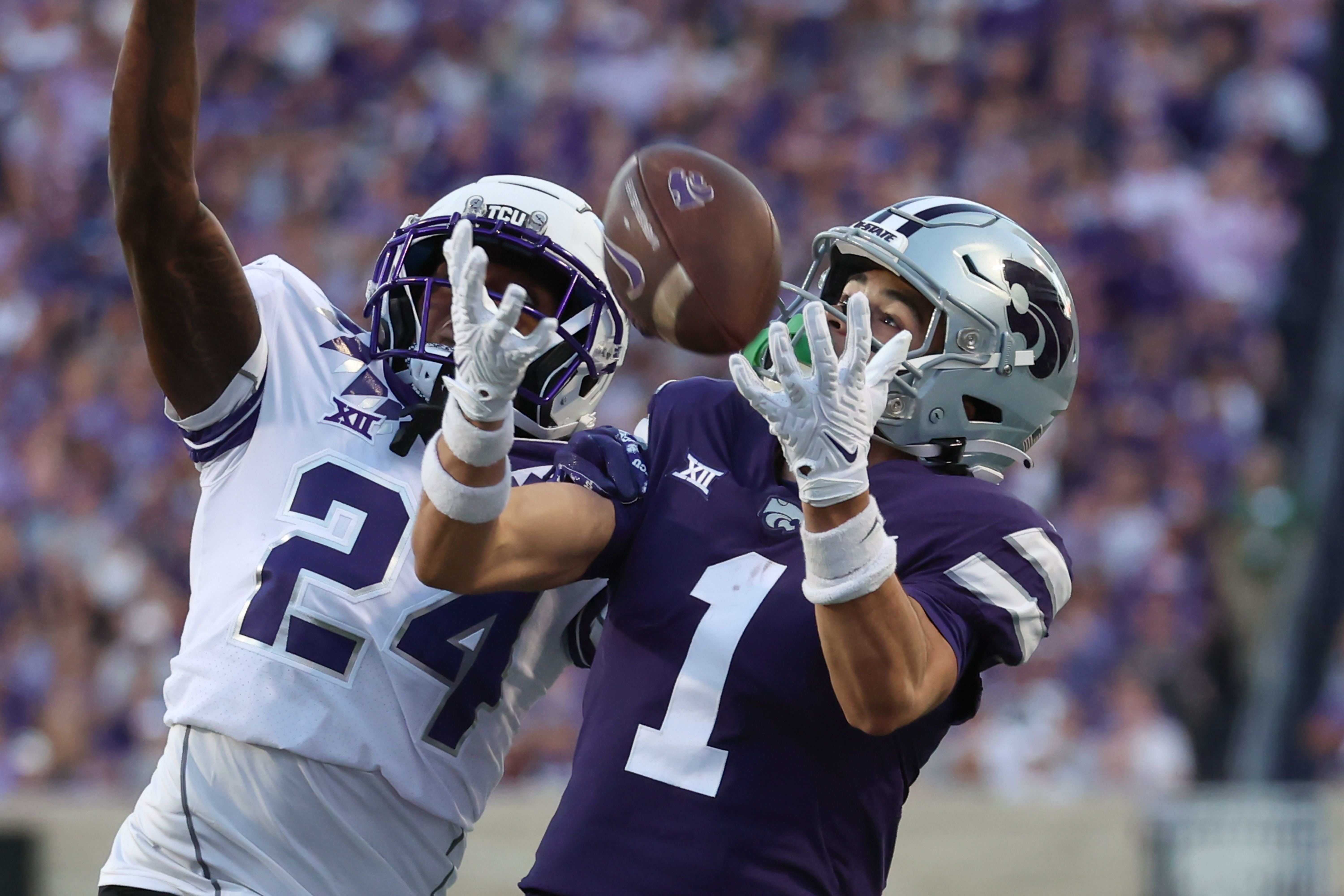 MANHATTAN, KS - OCTOBER 21: Kansas State Wildcats wide receiver Jayce Brown (1) makes a catch over TCU Horned Frogs cornerback Avery Helm (24) for 26-yards in the first quarter of a Big 12 college football game between the TCU Horned Frogs and Kansas State Wildcats on Oct 21, 2023 at Bill Snyder Family Stadium in Manhattan, KS.