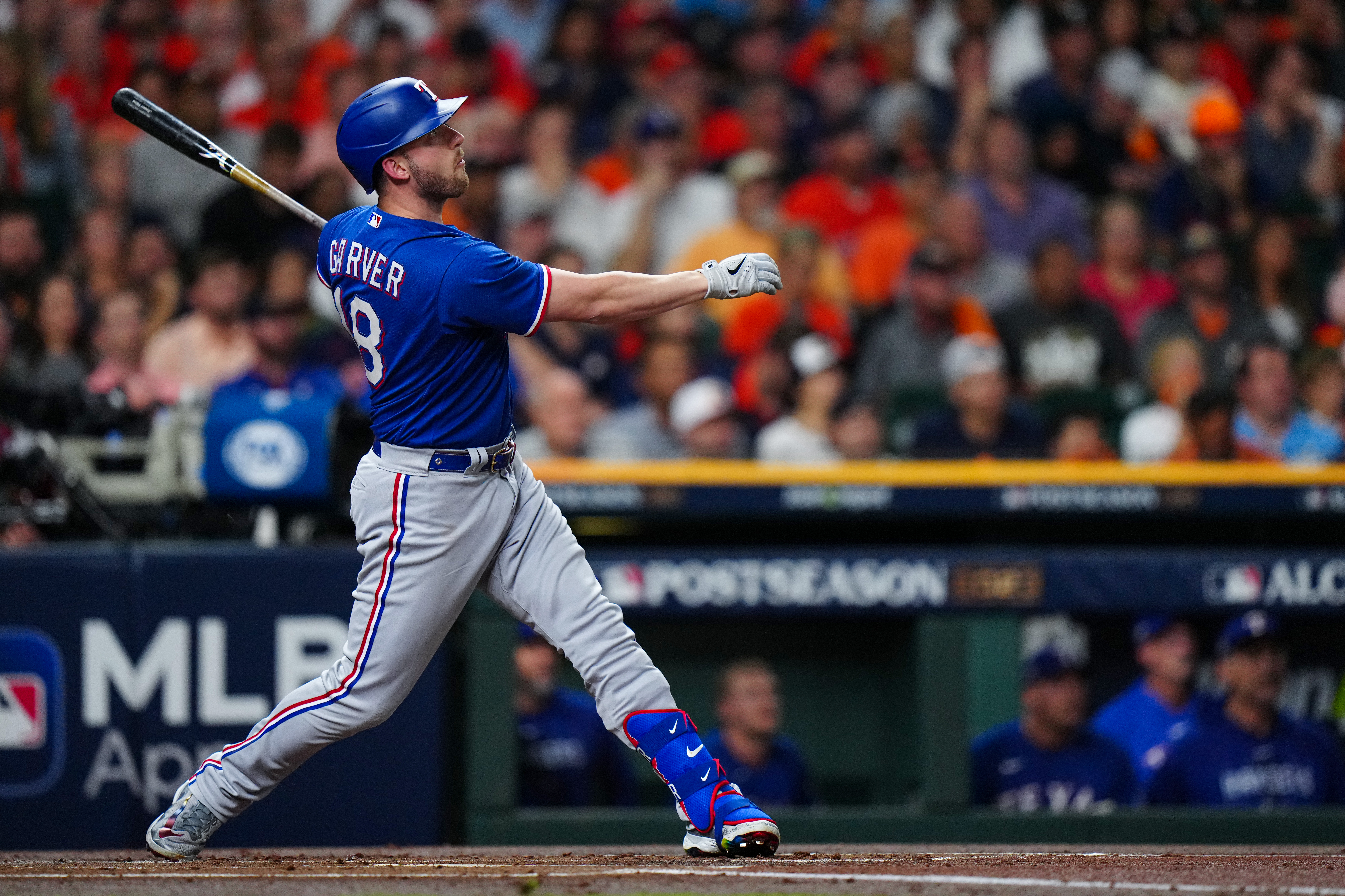 Mitch Garver of the Texas Rangers hits an RBI single in the first inning of Game 7 of the ALCS between the Texas Rangers and the Houston Astros at Minute Maid Park on Monday, October 23, 2023 in Houston, Texas.