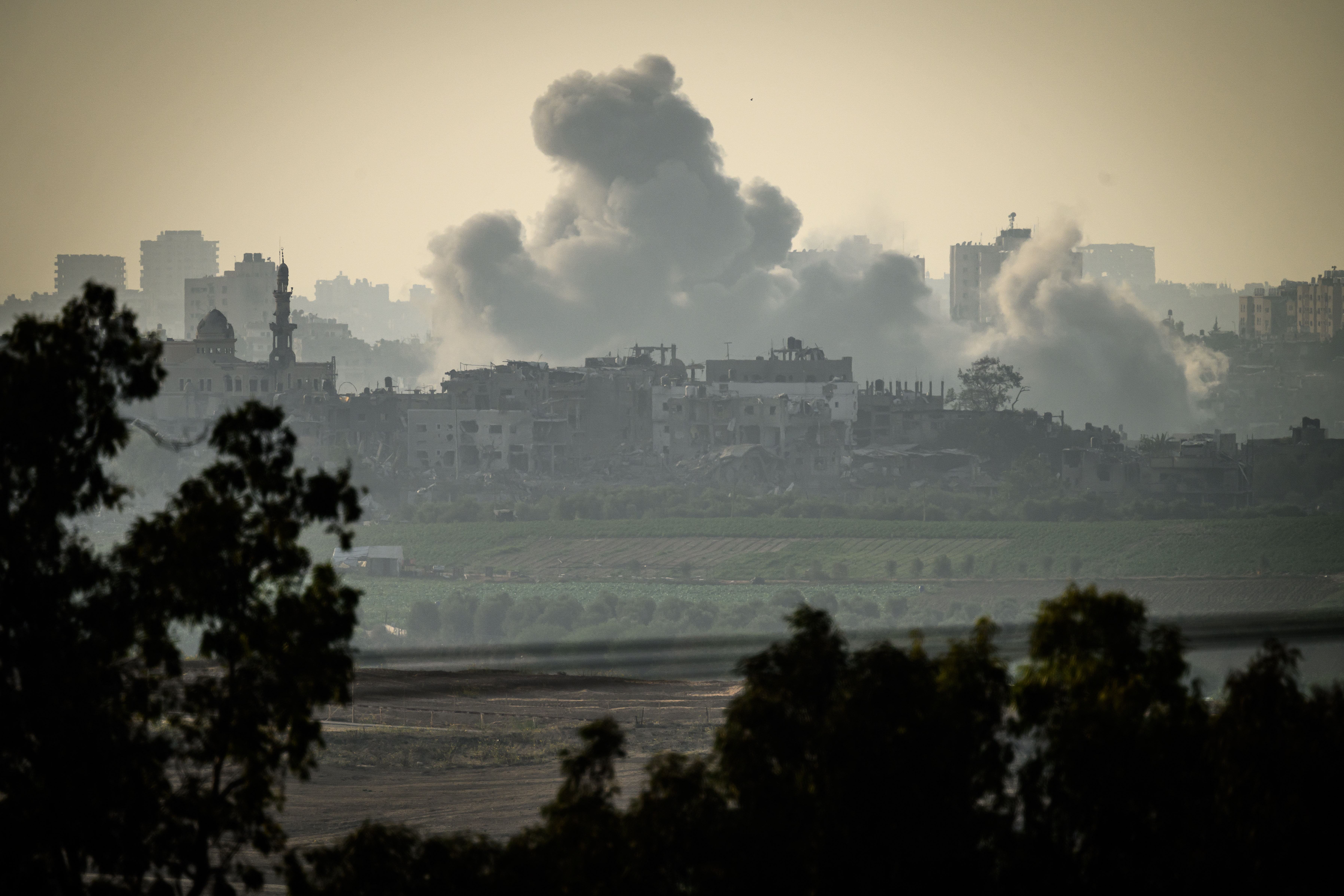 Smoke billows over buildings on a hill in Gaza City amid Israeli airstrikes on the city.
