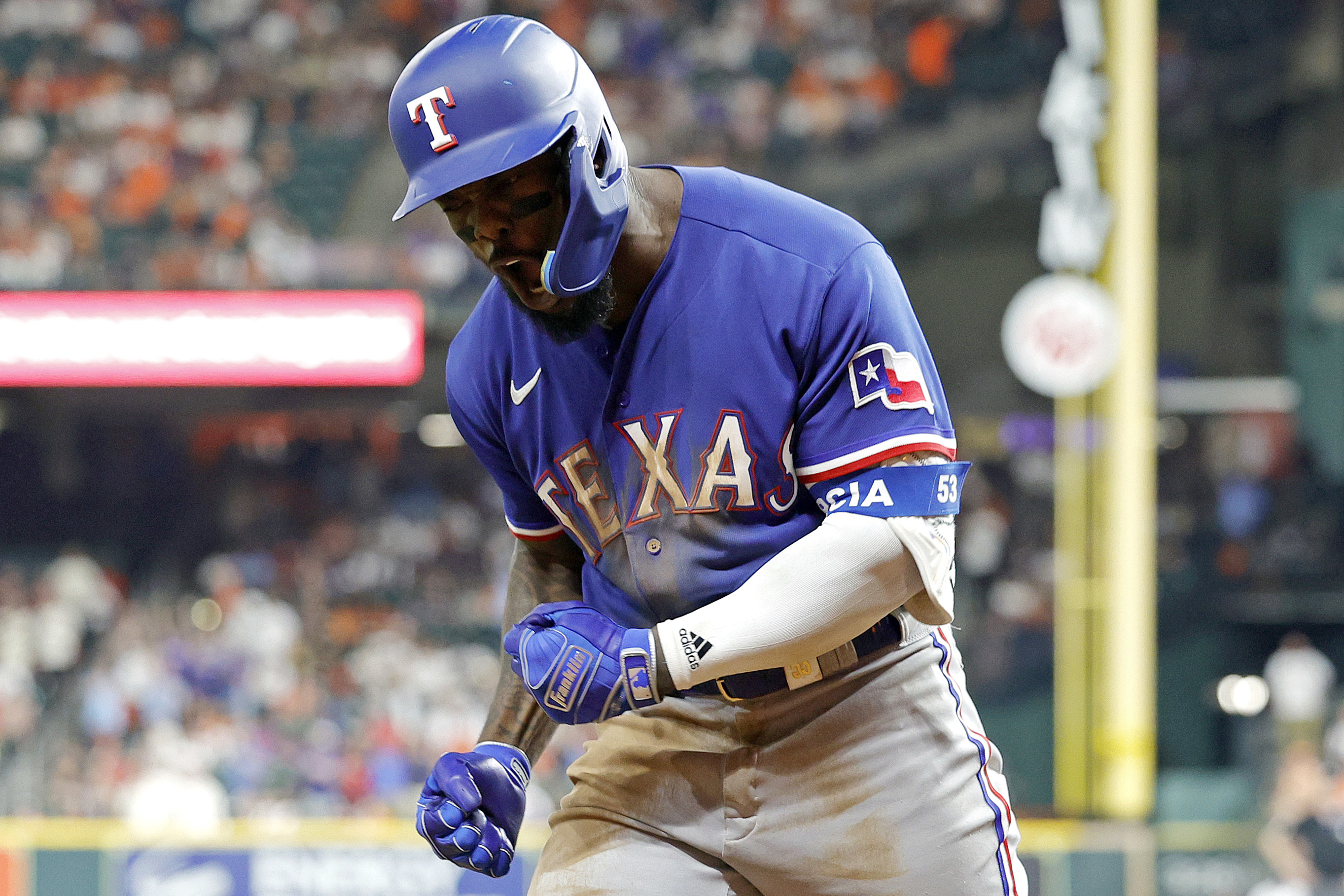 Adolis Garcia of the Texas Rangers celebrates after hitting a solo home run against Jose Urquidy of the Houston Astros during the eighth inning in Game Seven of the American League Championship Series at Minute Maid Park on October 23, 2023 in Houston, Texas.