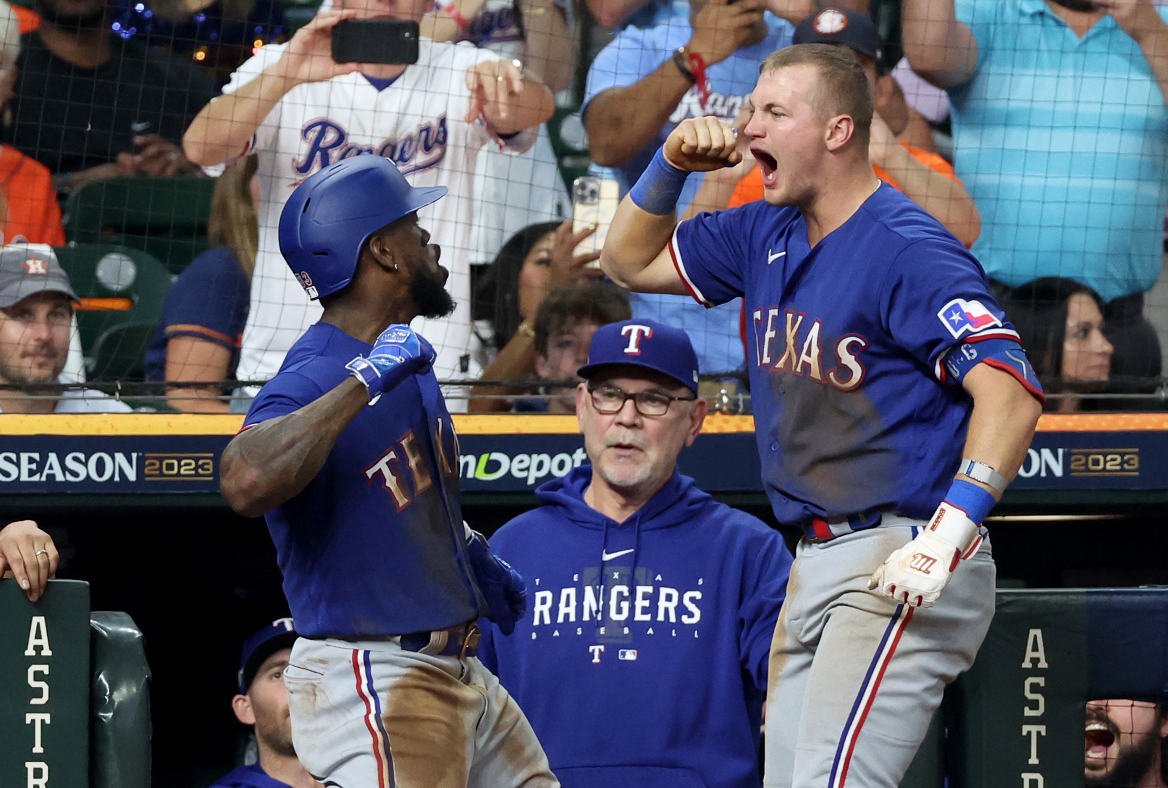 Texas Rangers right fielder Adolis Garcia celebrates with third baseman Josh Jung after hitting a home run during the third inning of game seven in the ALCS against the Houston Astros for the 2023 MLB playoffs at Minute Maid Park.&nbsp;