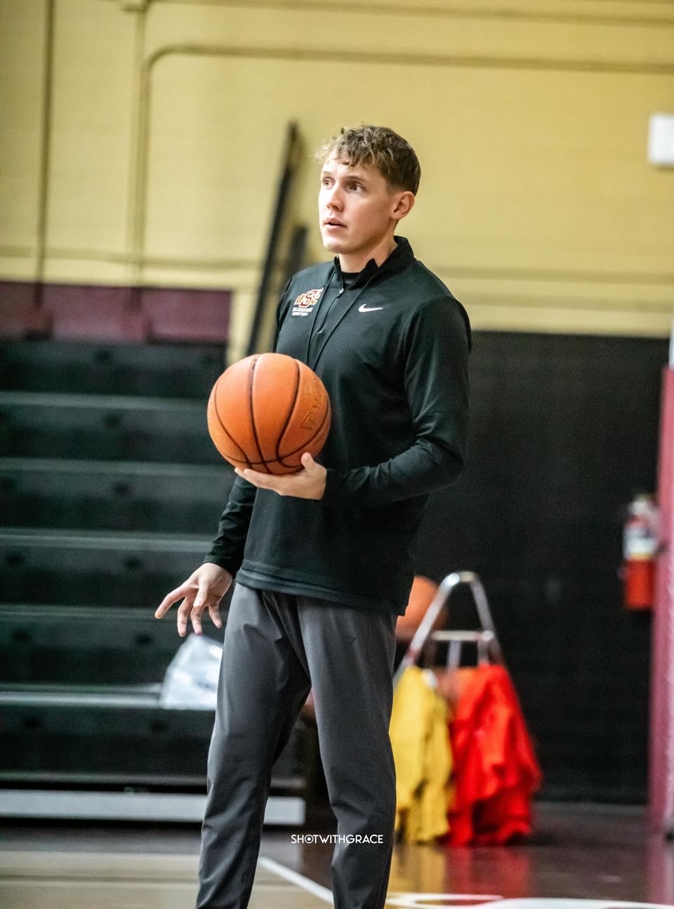 Matt Lynch holds a basketball on the court at the University of South Carolina Salkehatchie.