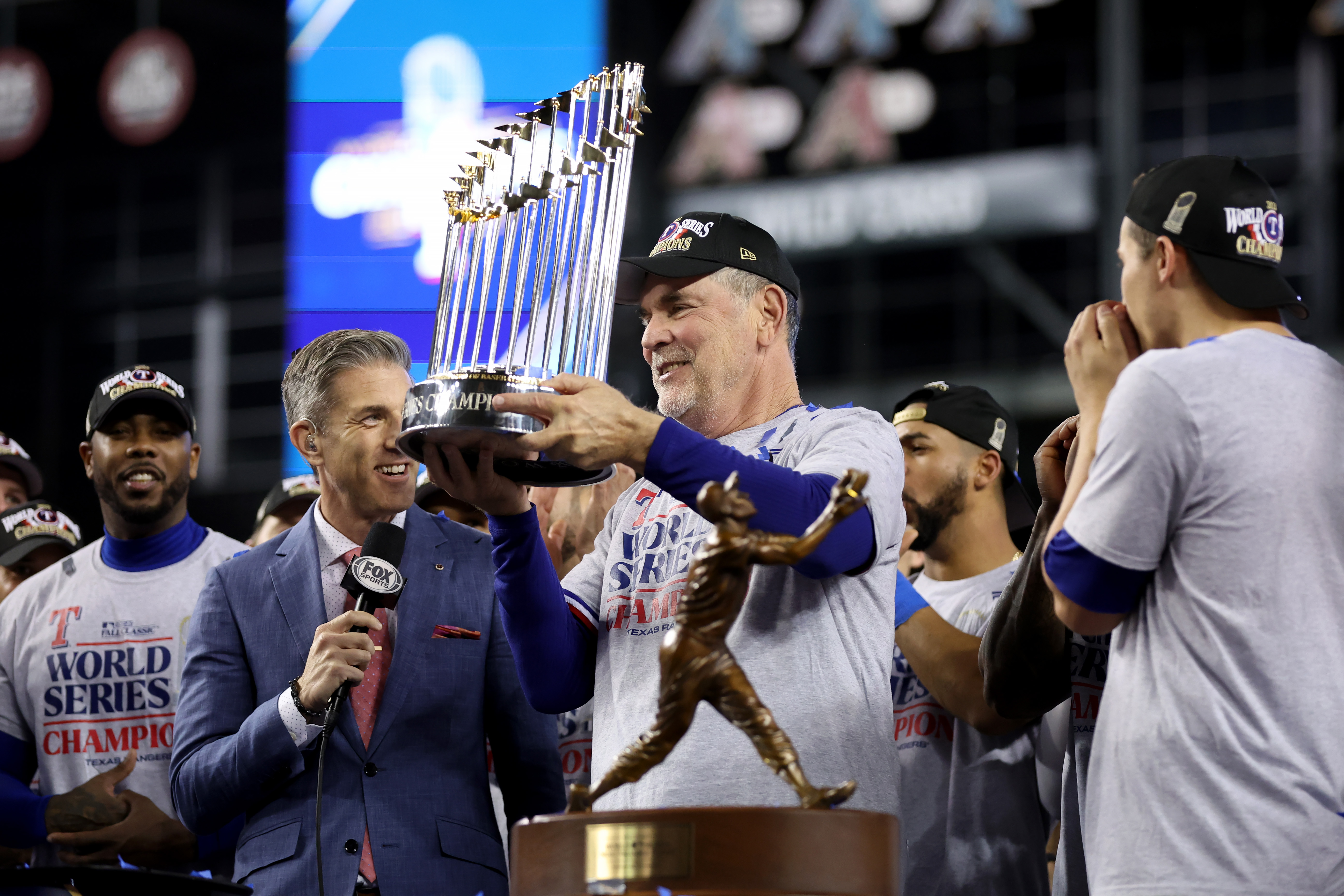 Manager Bruce Bochy of the Texas Rangers hoists the Commissioner’s Trophy after the Texas Rangers beat the Arizona Diamondbacks 5-0 in Game Five to win the World Series at Chase Field on November 01, 2023 in Phoenix, Arizona.