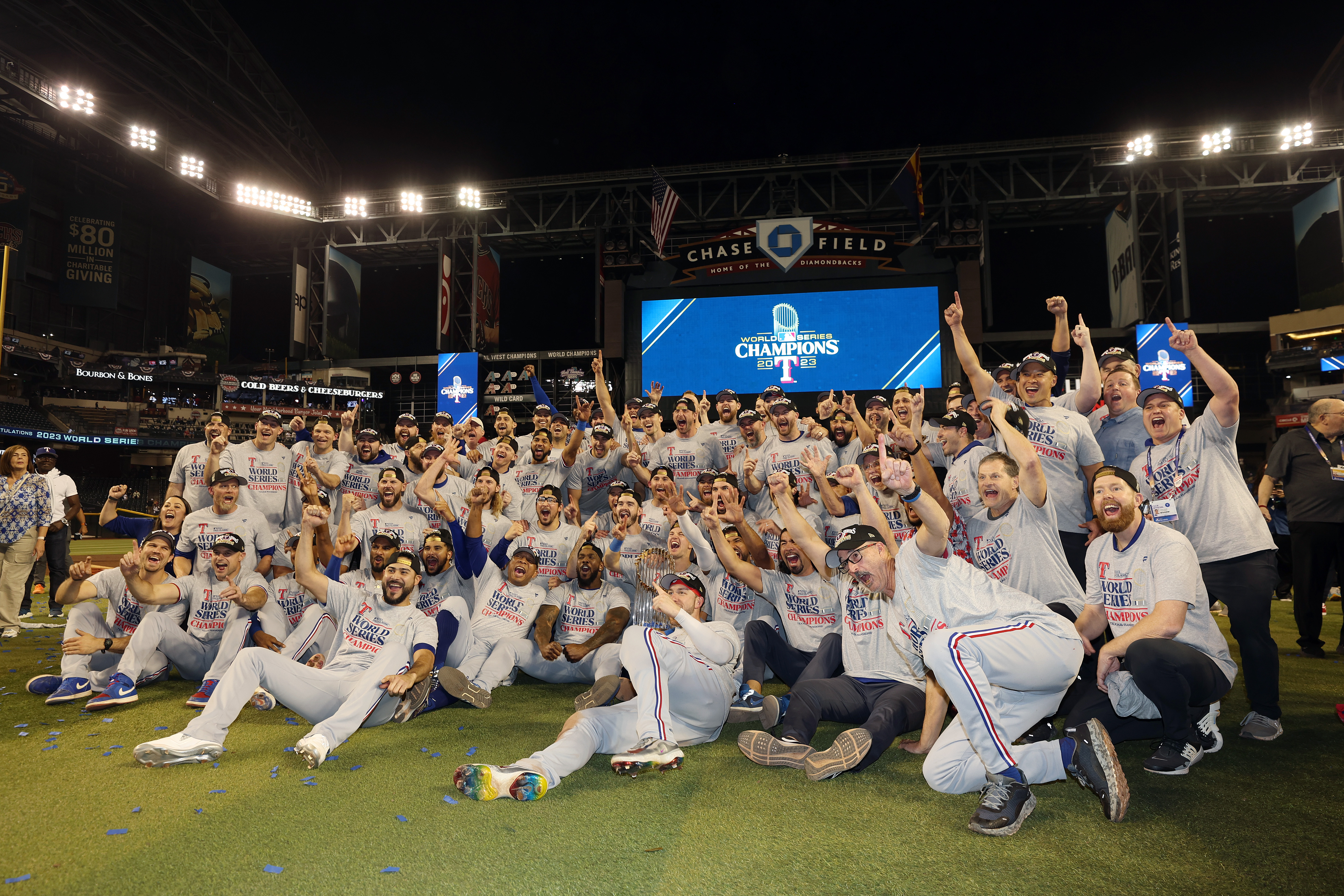 The Texas Rangers pose for photos after beating the Arizona Diamondbacks 5-0 in Game Five to win the World Series at Chase Field on November 01, 2023 in Phoenix, Arizona.