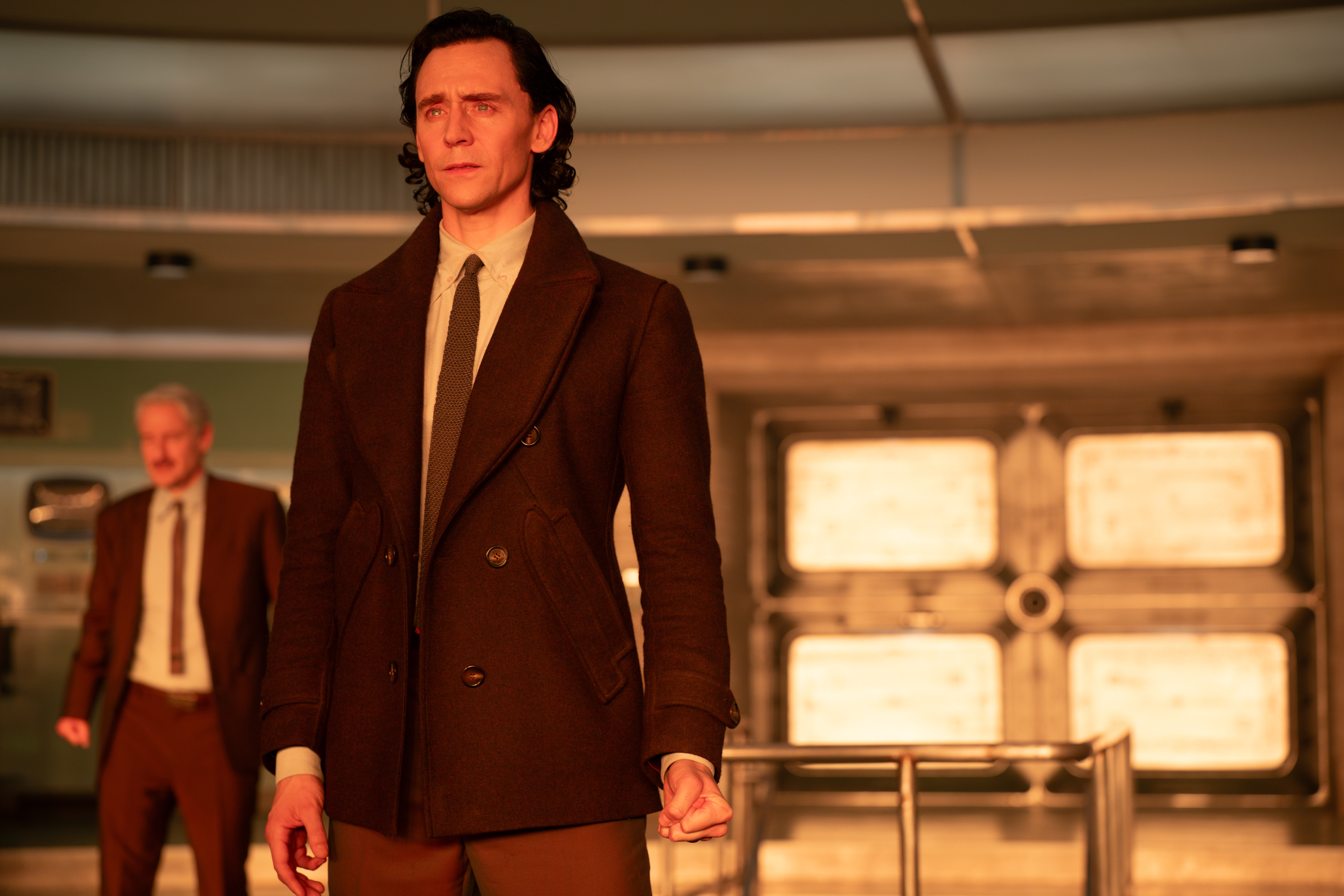 Loki (Tom Hiddleston) looking sad at something in the TVA control room