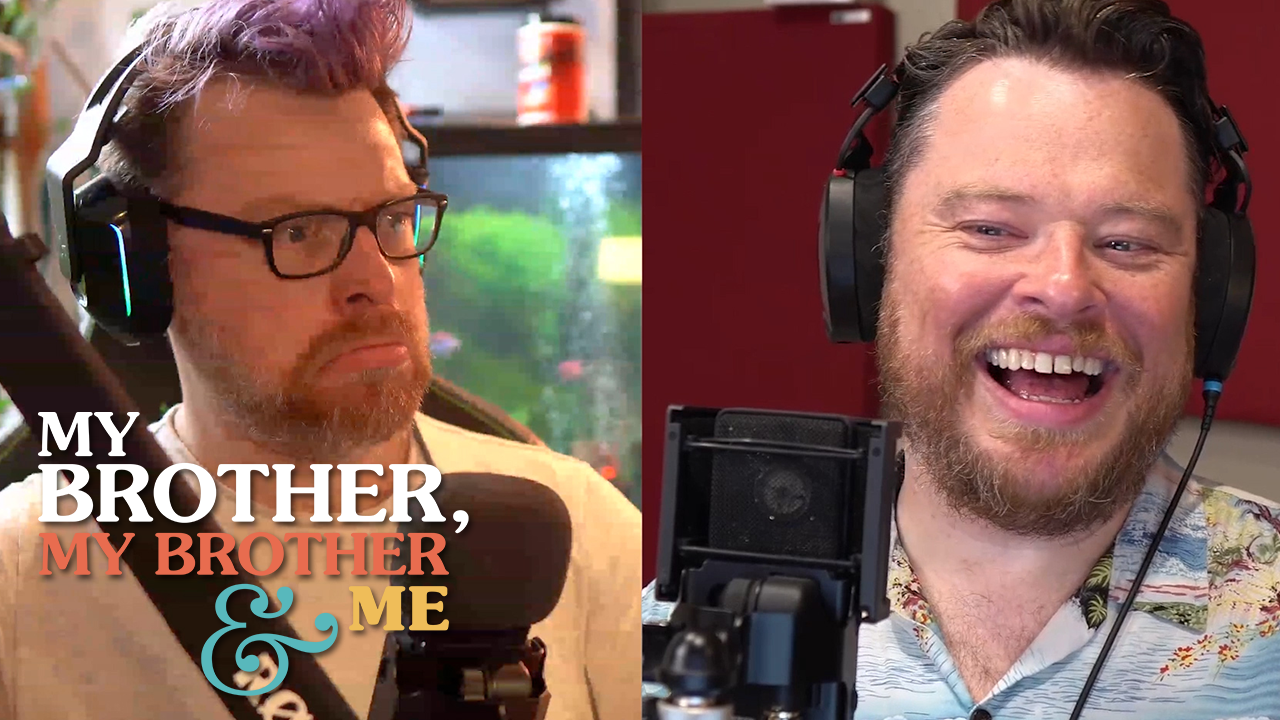 An image of Travis McElroy on the left, and Justin McElroy on the right, they are each in their own offices, seated behind microphones and wearing headphones. Travis is also wearing glasses and is frowning. Justin is laughing. The My Brother My Brother and Me logo is superimposed over the bottom left corner.