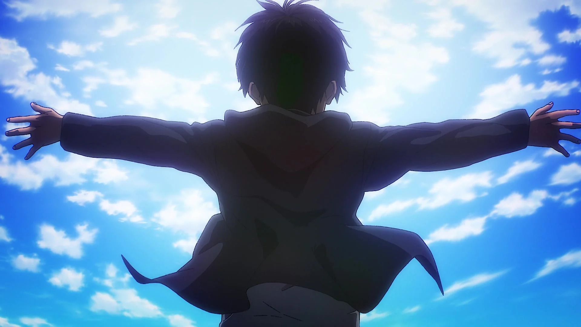 Eren standing above the camera with his arms open facing a big blue sky 