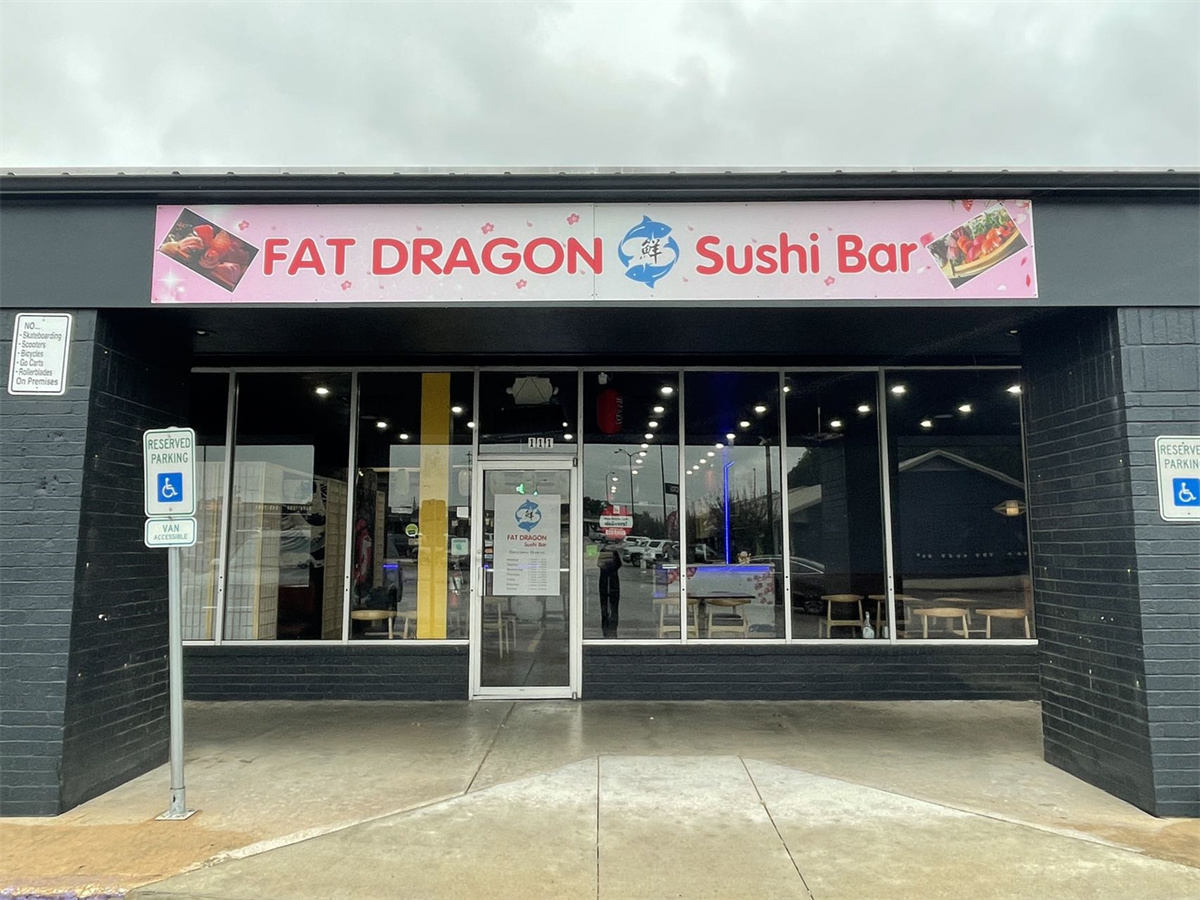 A restaurant facade with a sign reading Fat Dragon Sushi Bar.