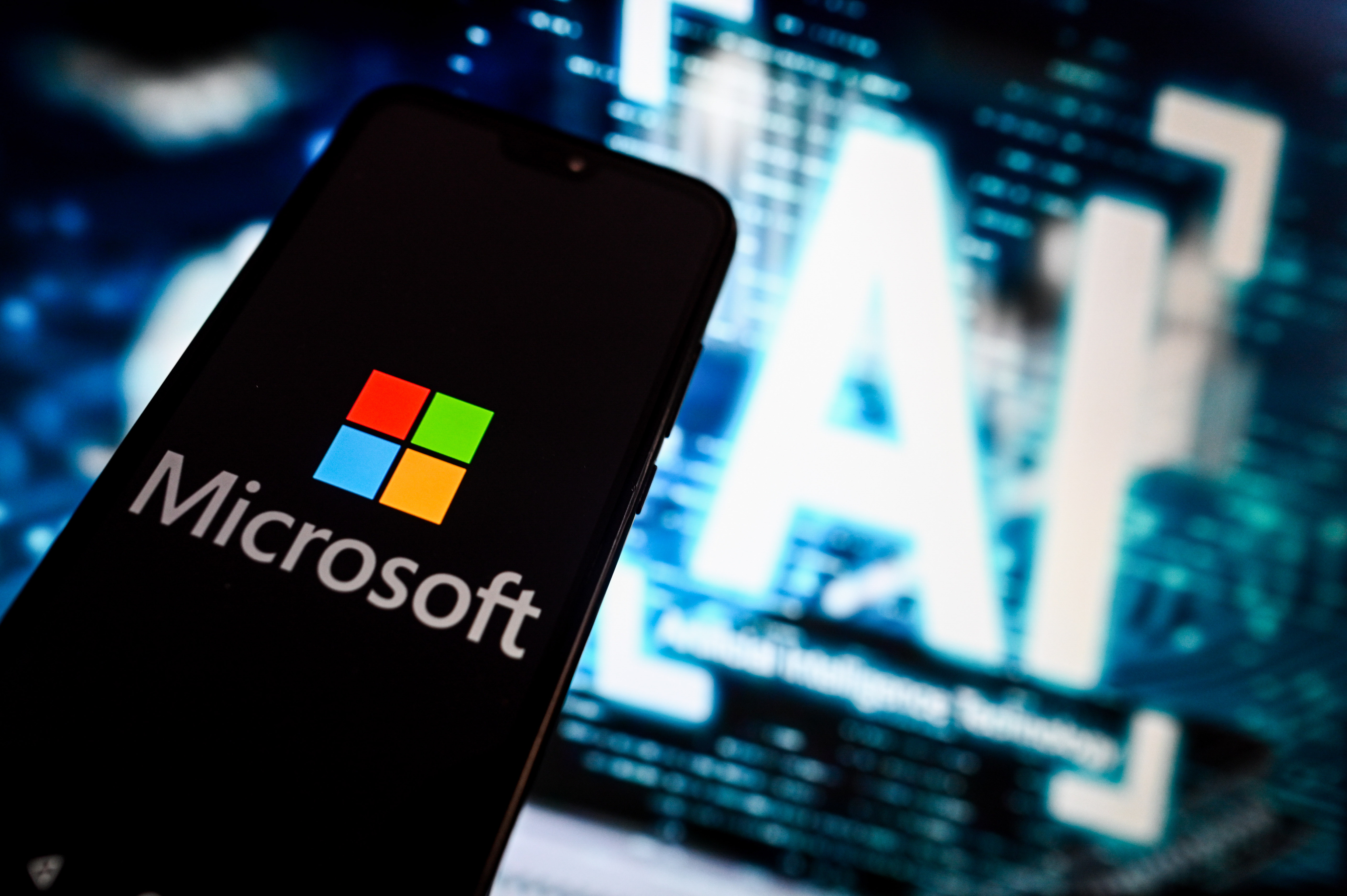 In this photo illustration, a Microsoft logo is displayed on an iPhone