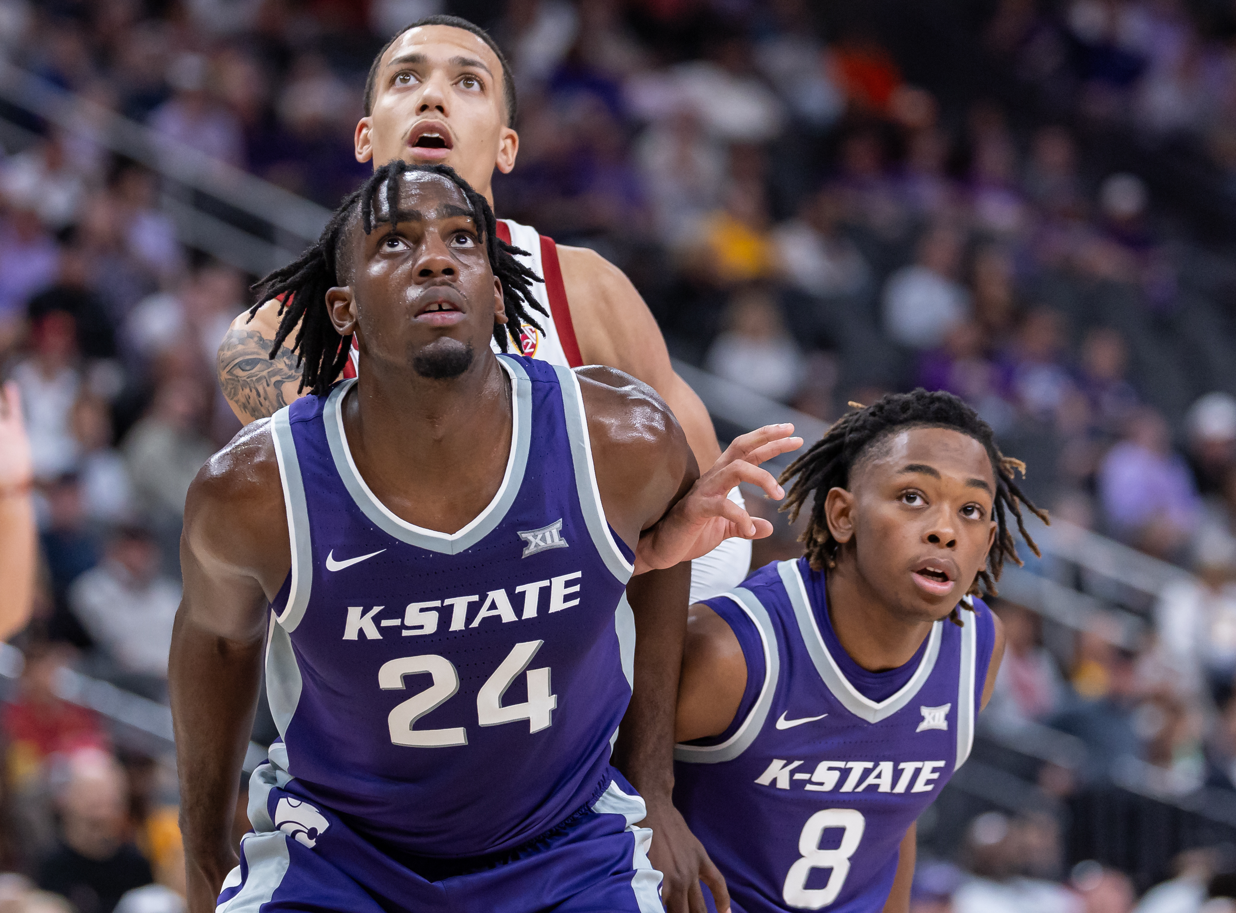 Arthur Kaluma #24 and R.J. Jones #8 of the Kansas State Wildcat blocks out during the game against the USC Trojans in the Naismith Hall of Fame Series at T-Mobile Arena on November 6, 2023 in Las Vegas, Nevada.