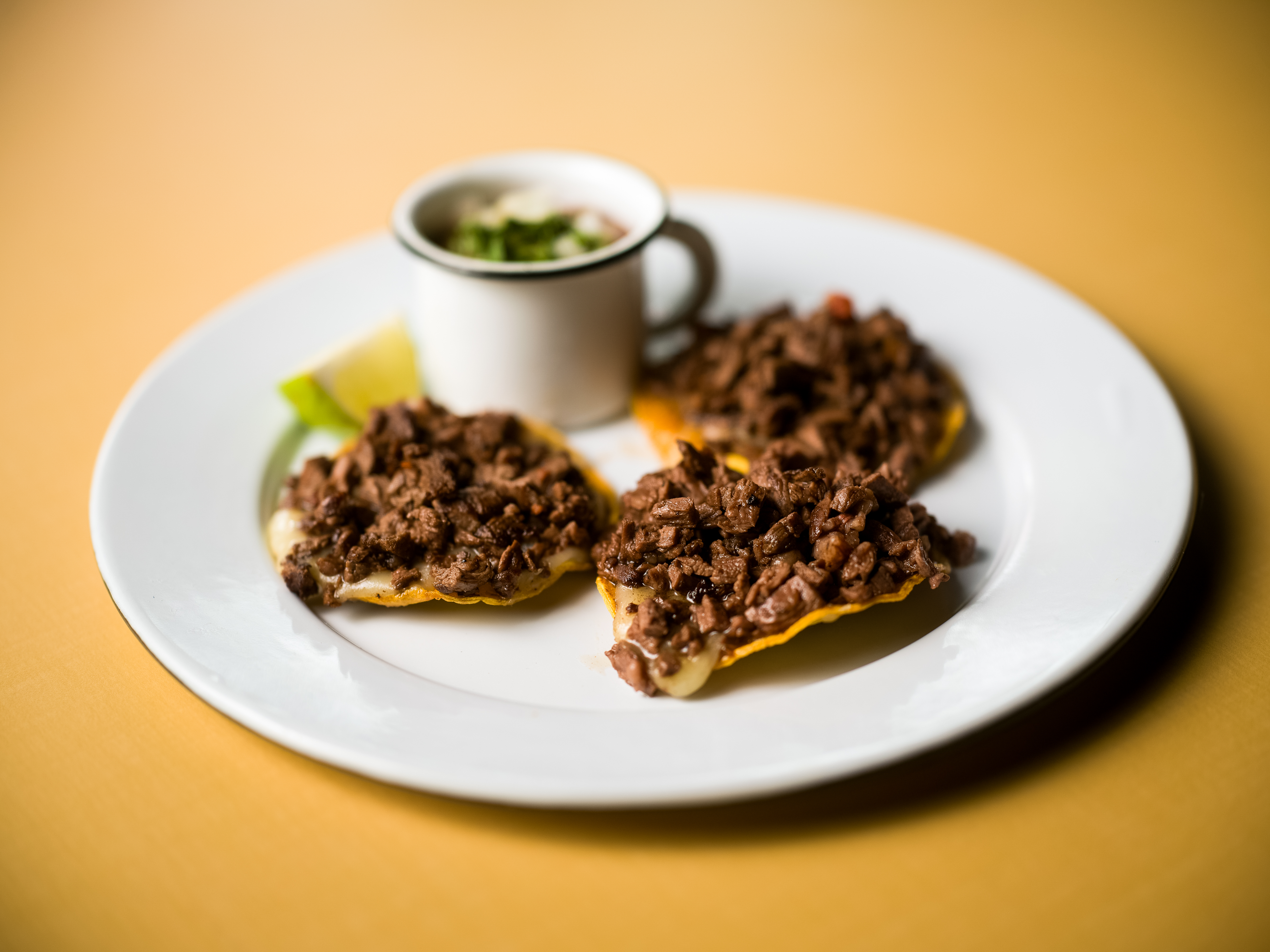 Volcán de bistec, or crispy tortillas topped with shredded beef, with a side of salsa.