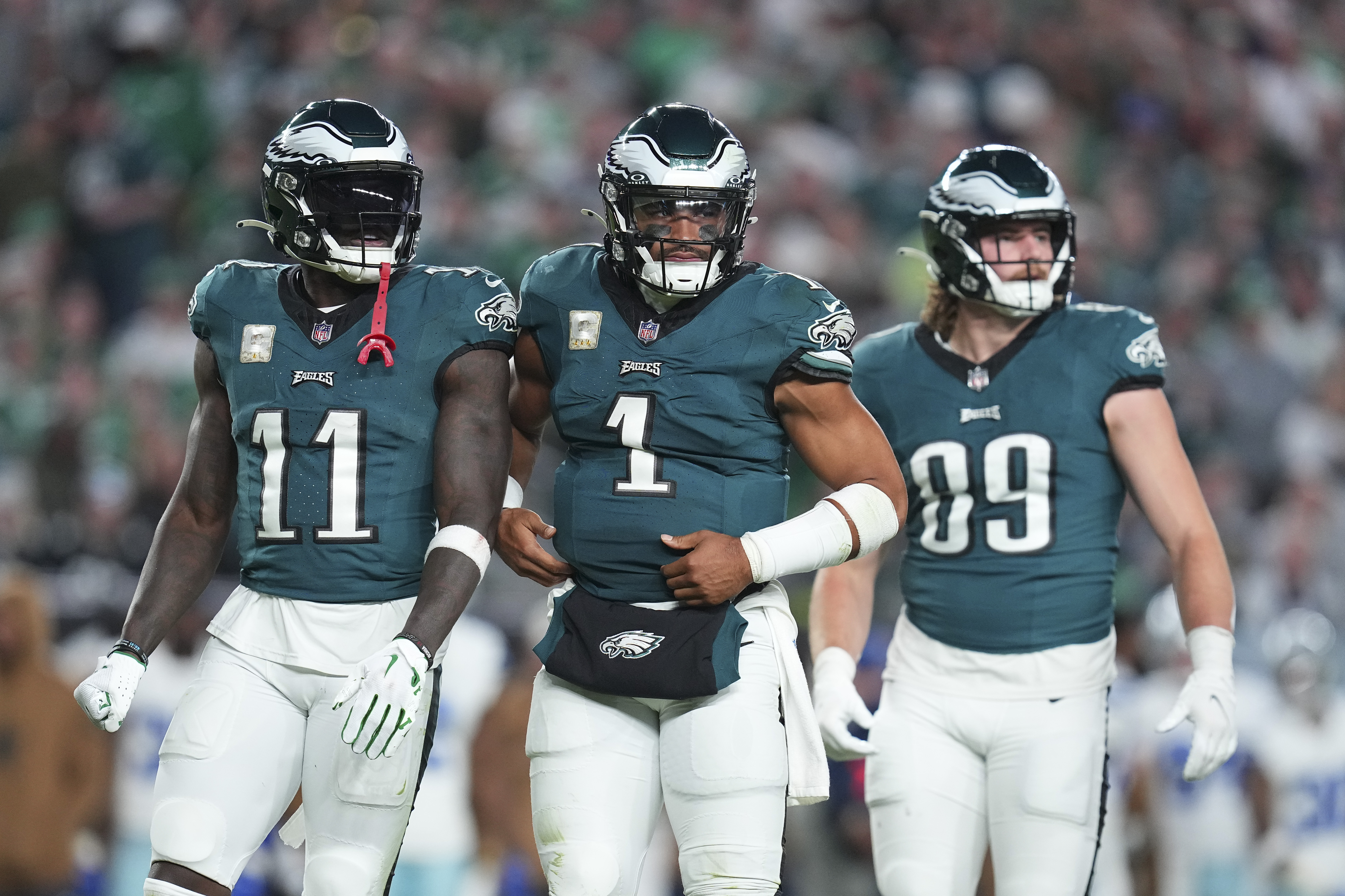 A.J. Brown, Jalen Hurts, and Jack Stoll of the Philadelphia Eagles look on against the Dallas Cowboys at Lincoln Financial Field on November 5, 2023 in Philadelphia, Pennsylvania.