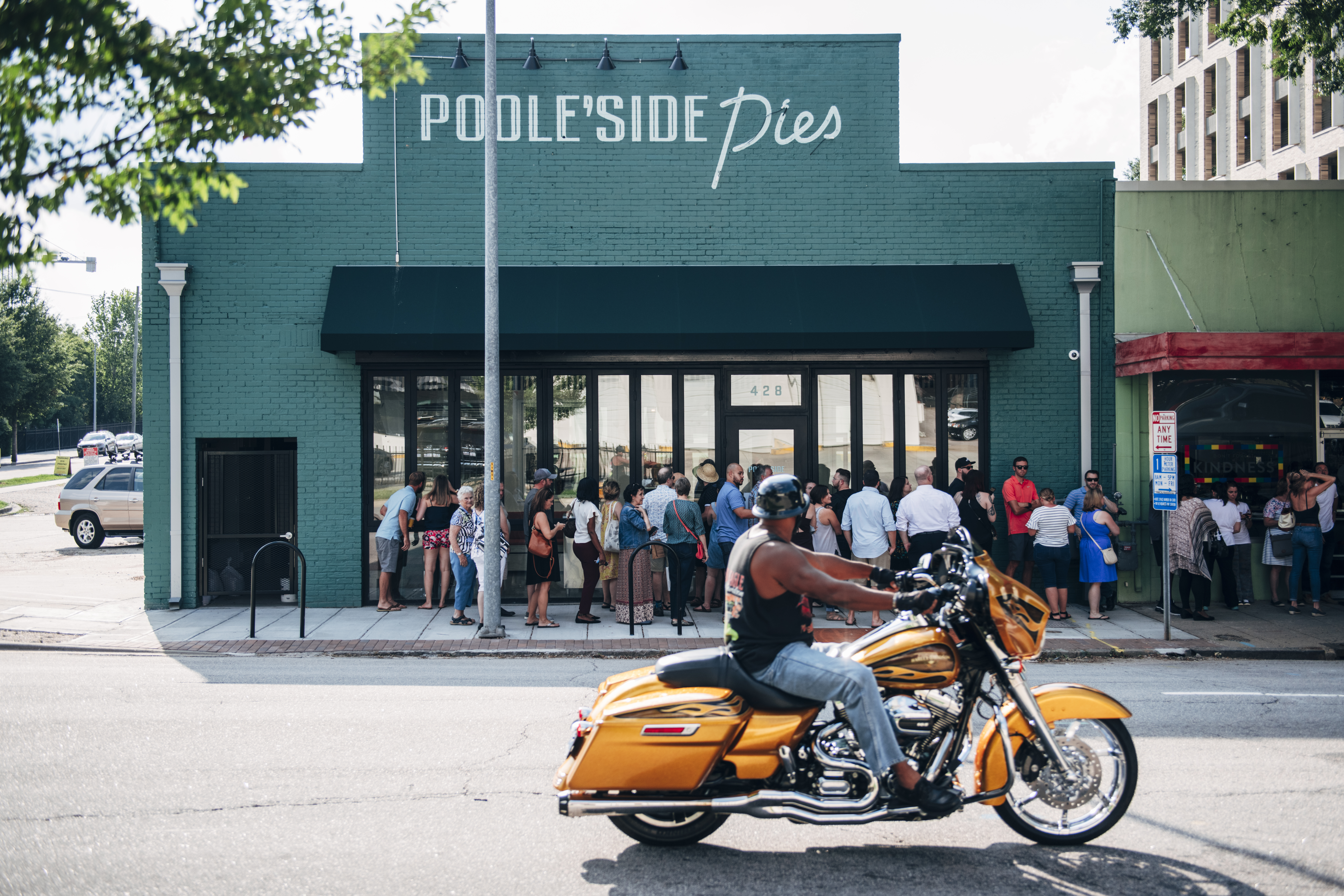 The exterior of Poole’side Pies with a line of people. 