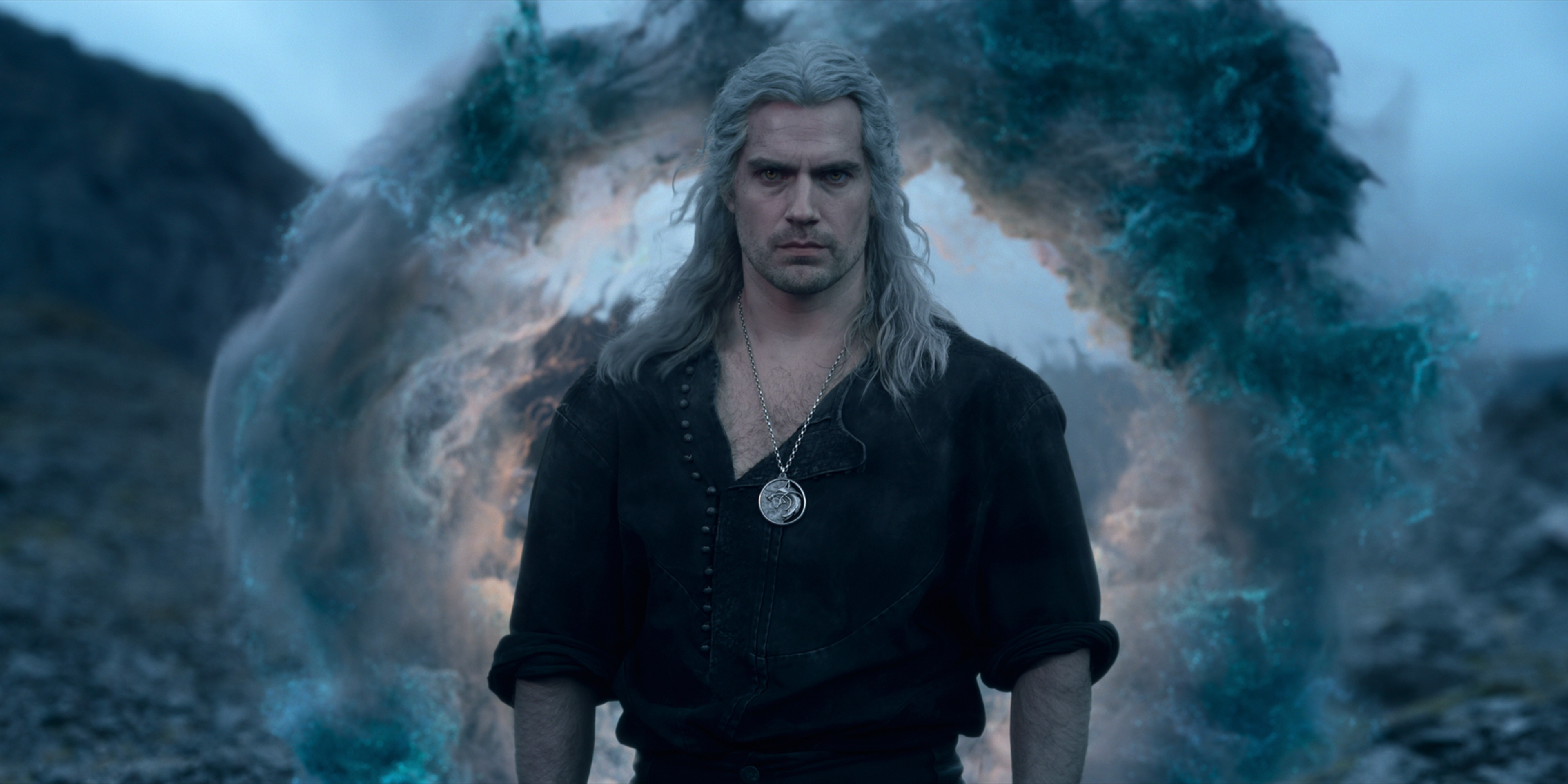 Henry Cavill as Geralt in front of a ring of smoke in The Witcher.