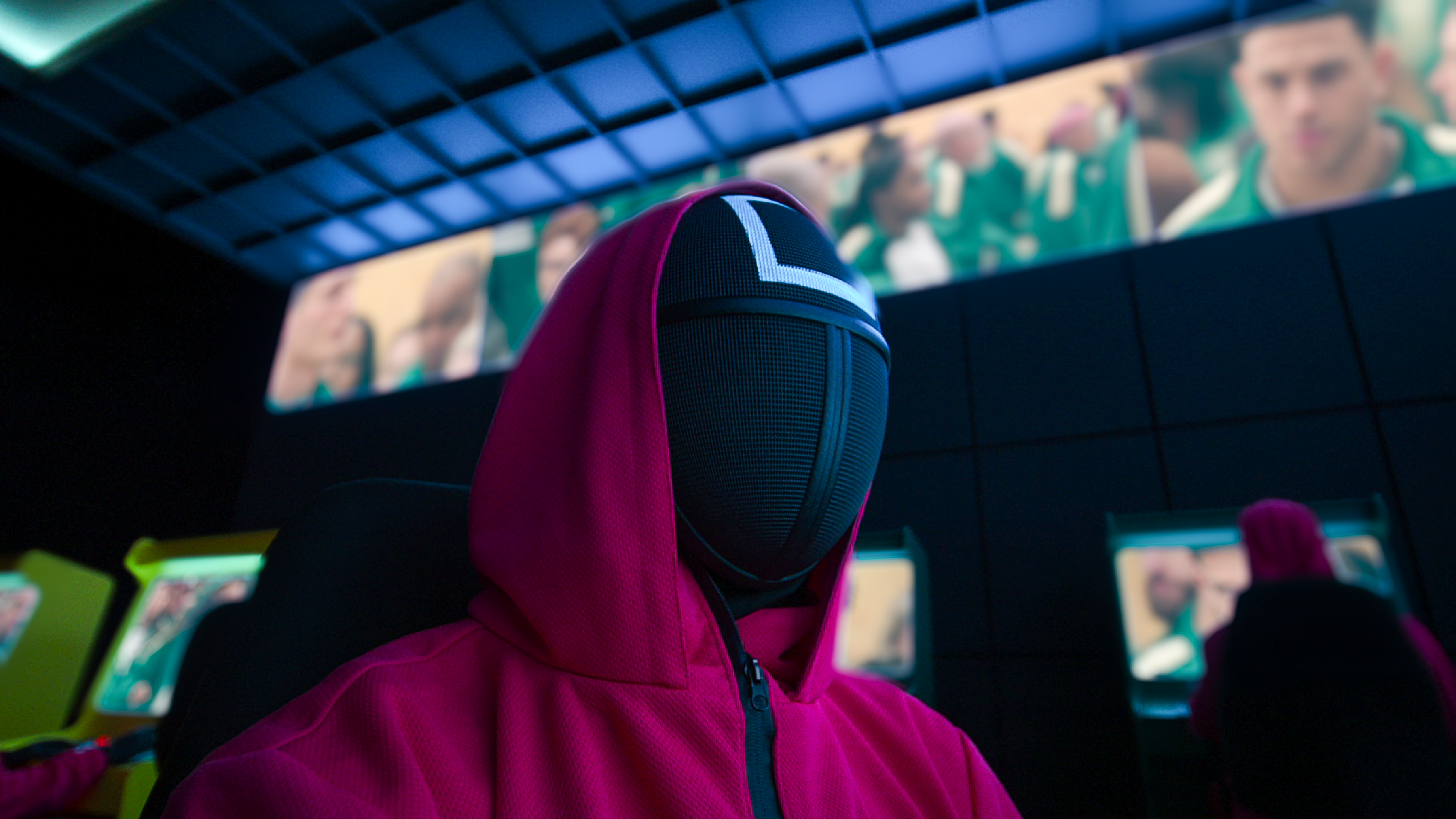 A person wearing a full-face mask and hoodie.