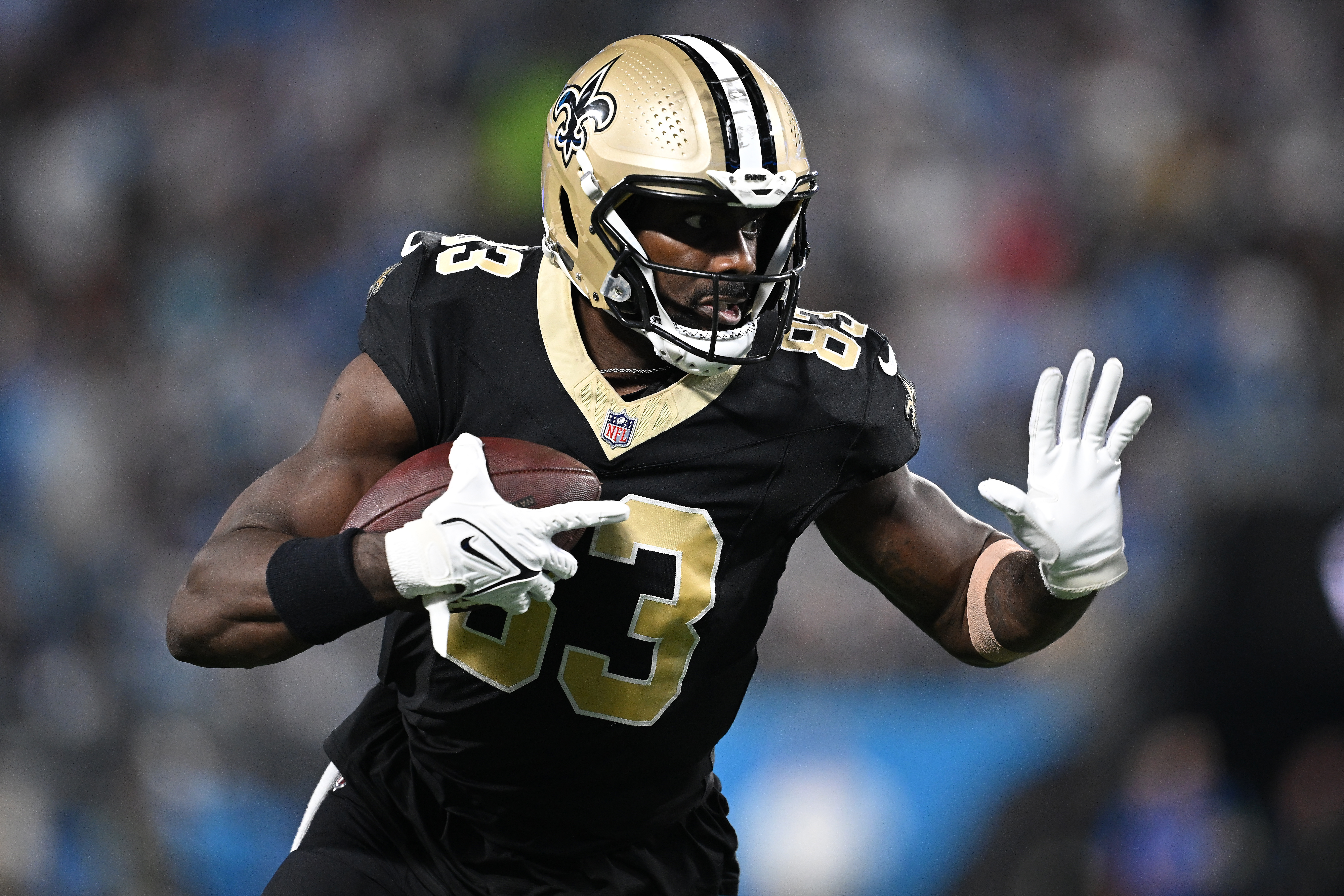 CHARLOTTE, NORTH CAROLINA - SEPTEMBER 18: Juwan Johnson #83 of the New Orleans Saints runs the ball after making a catch Carolina Panthers during their game at Bank of America Stadium on September 18, 2023 in Charlotte, North Carolina.