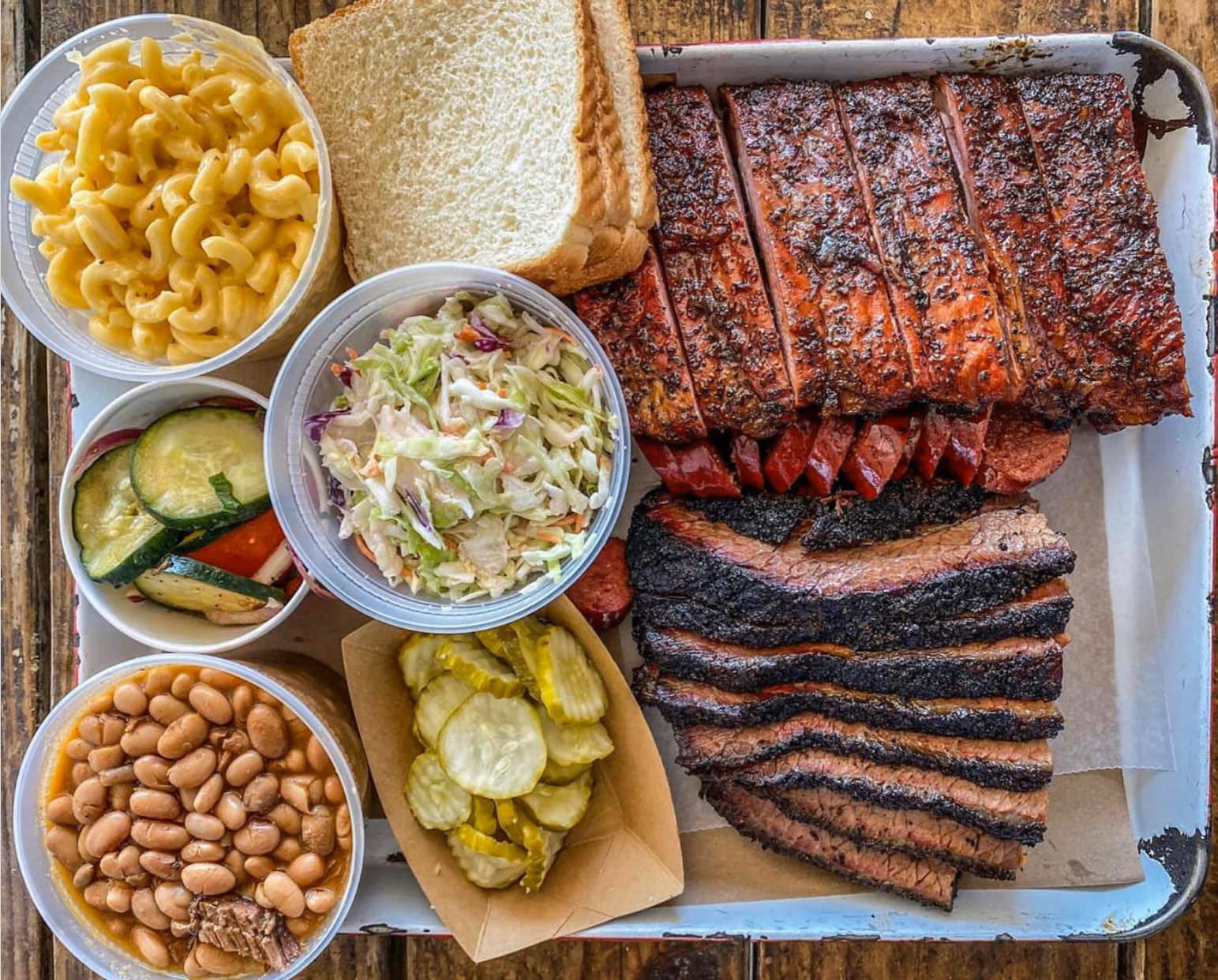 A tray of barbecue meats and sides. 