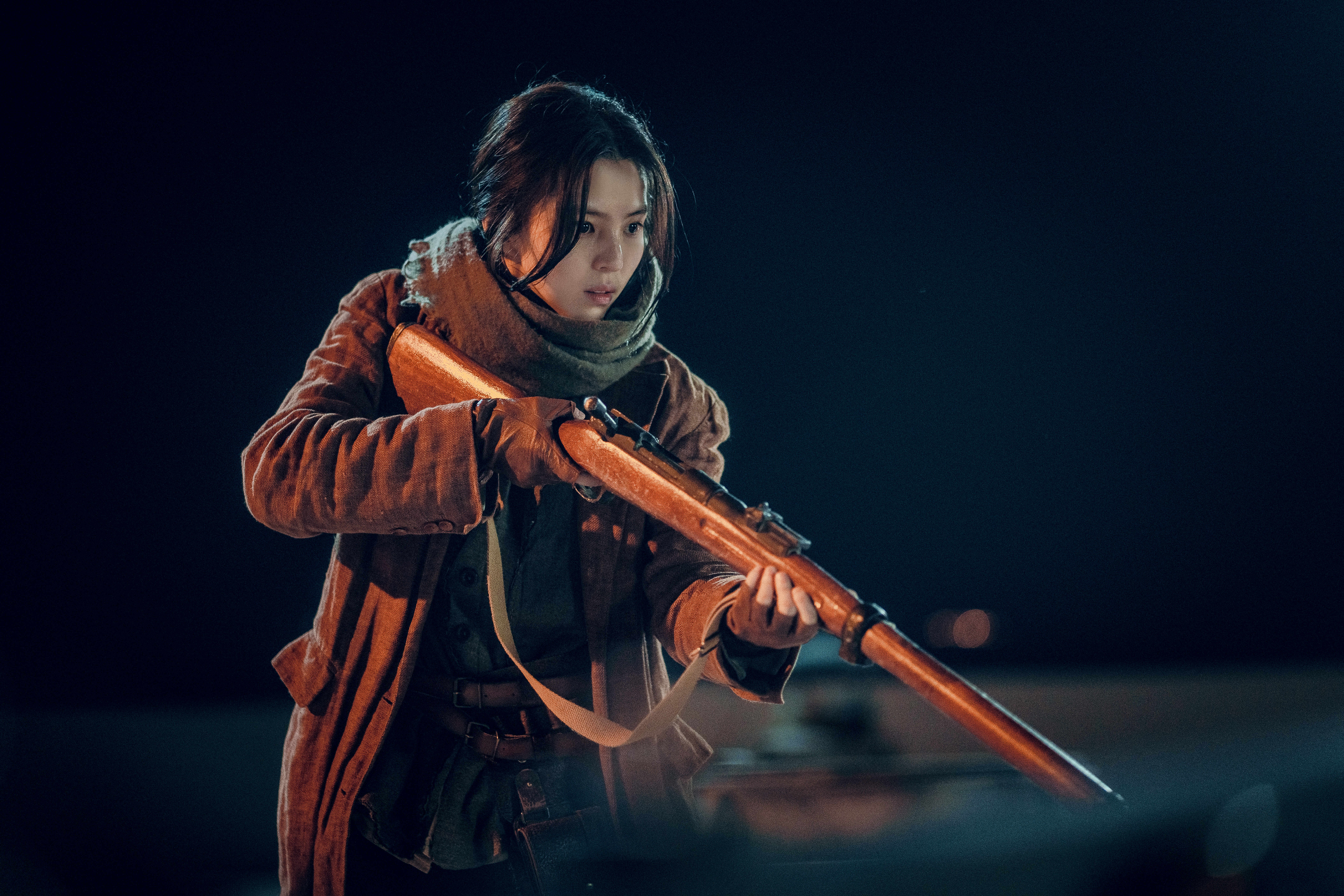 Han So-hee as Yoon Chae-ok holding a WW2-era rifle in Gyeongseong Creature on Netflix