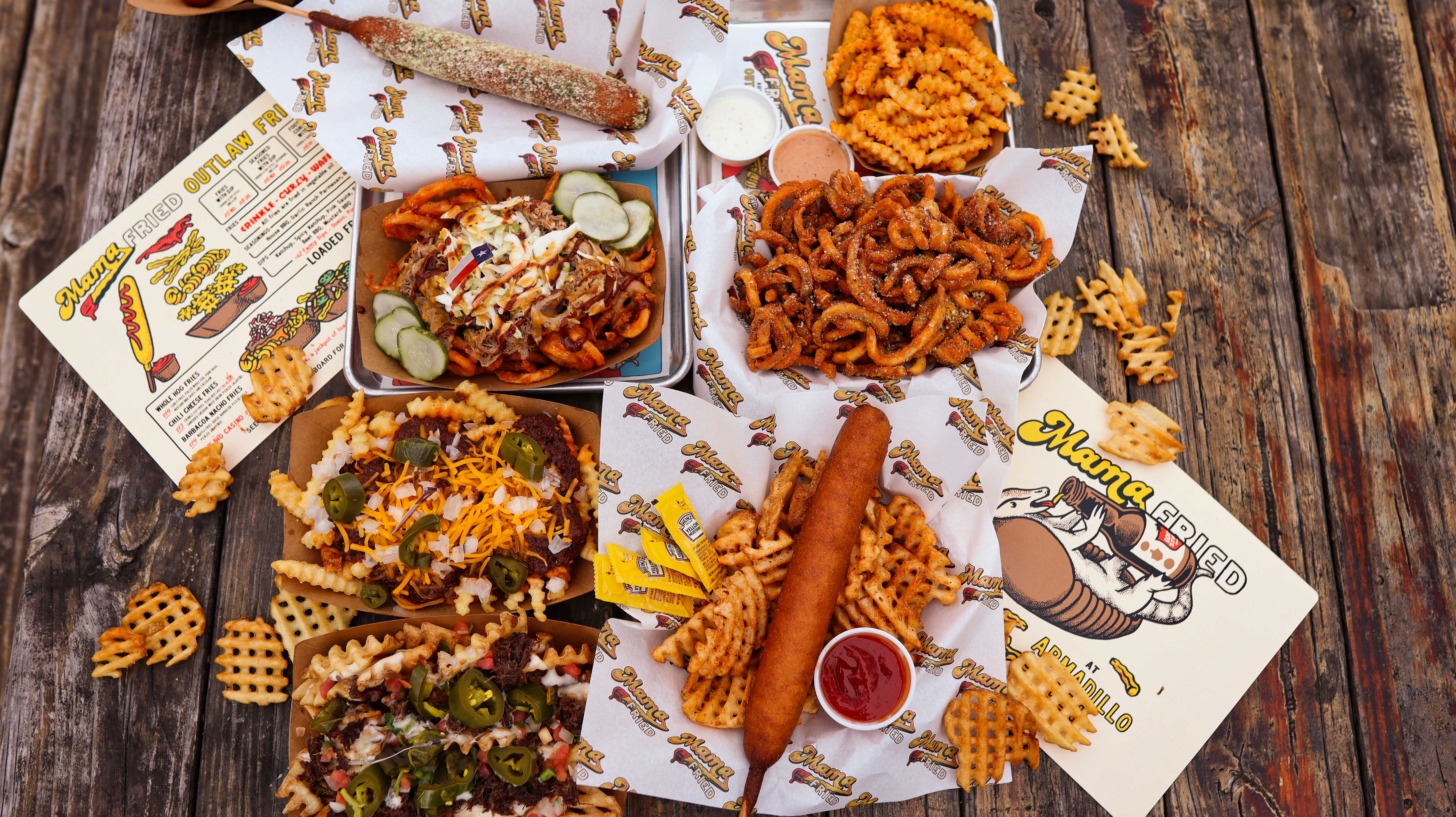 A table full of fries and corn dogs. 