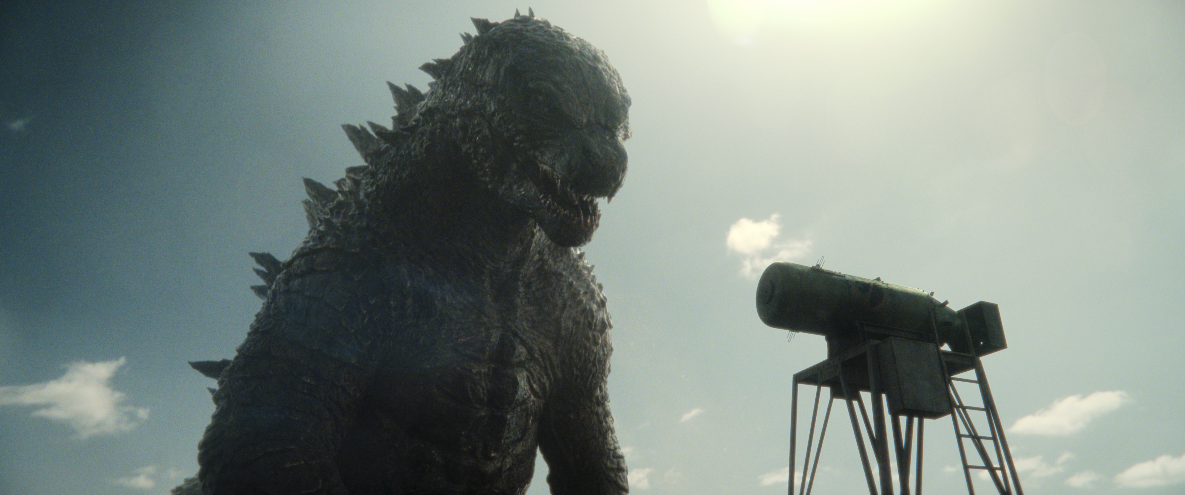 Godzilla looking down at a missile that looks small compared to him