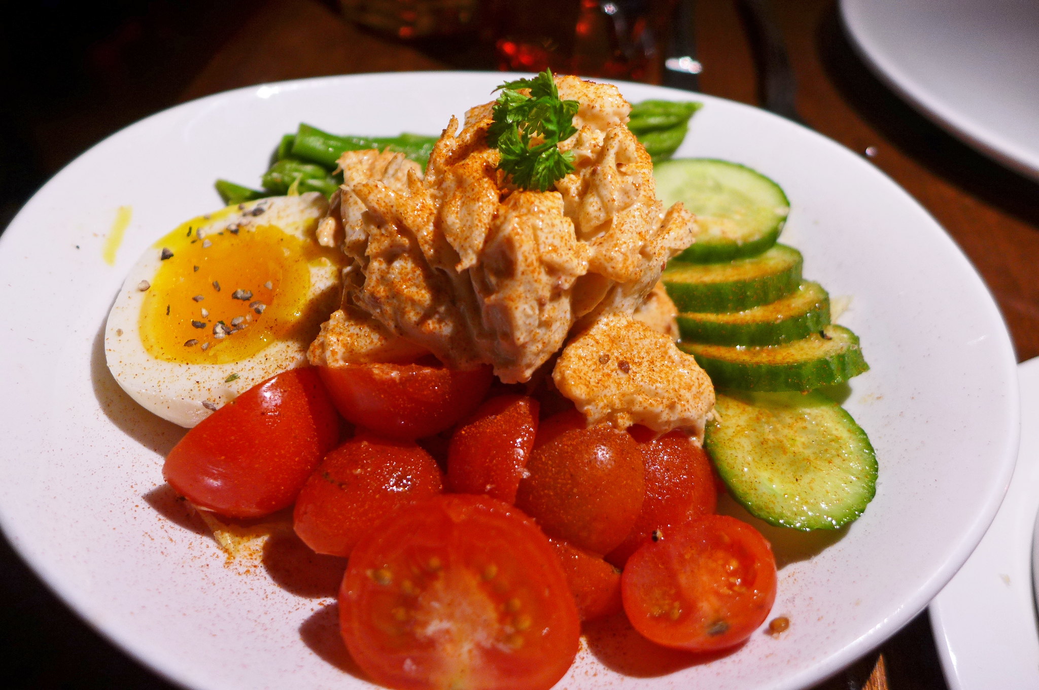 Eggs, cucumber, tomato, and crab in a salad. 