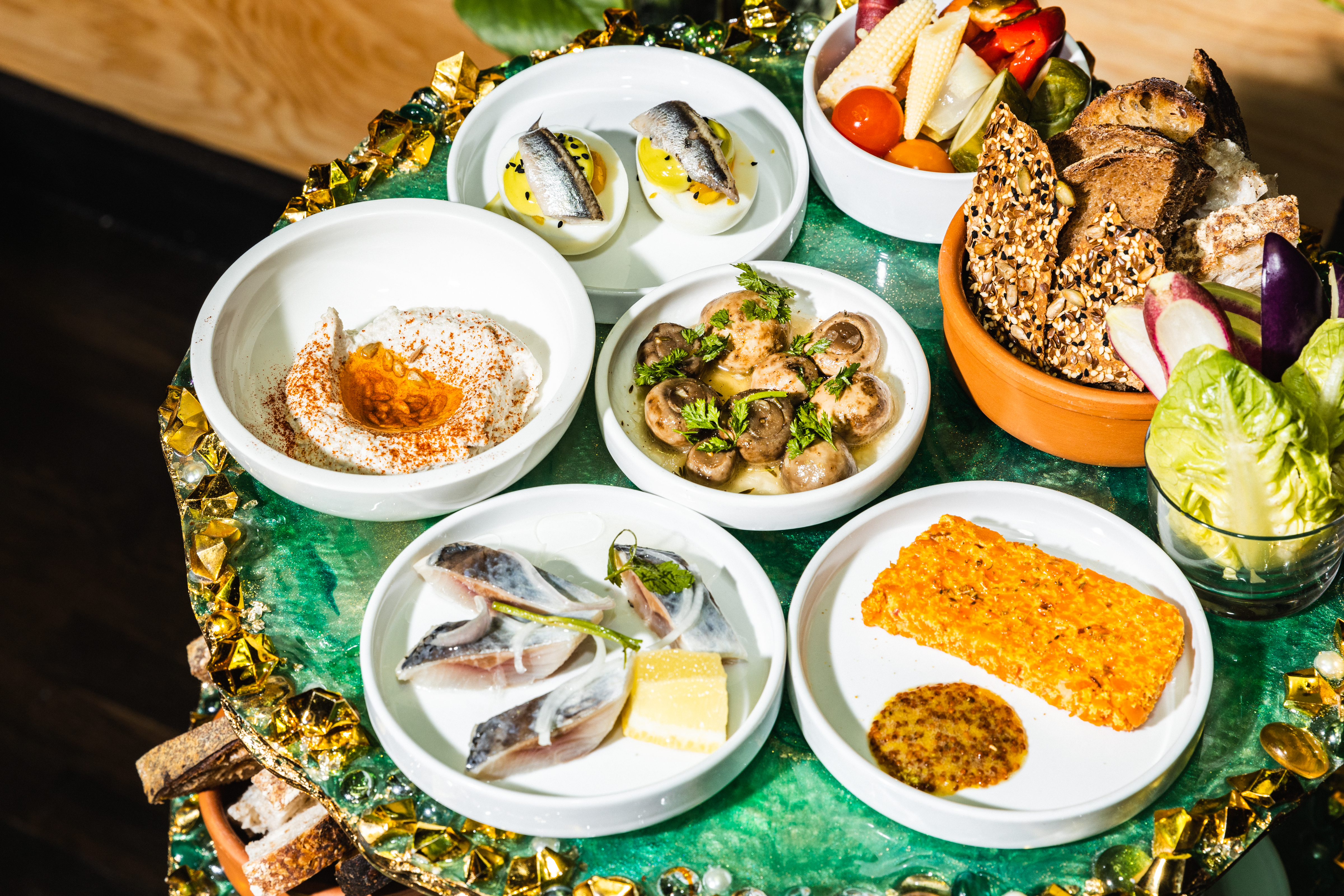 A display of small plates of Ukrainian food.