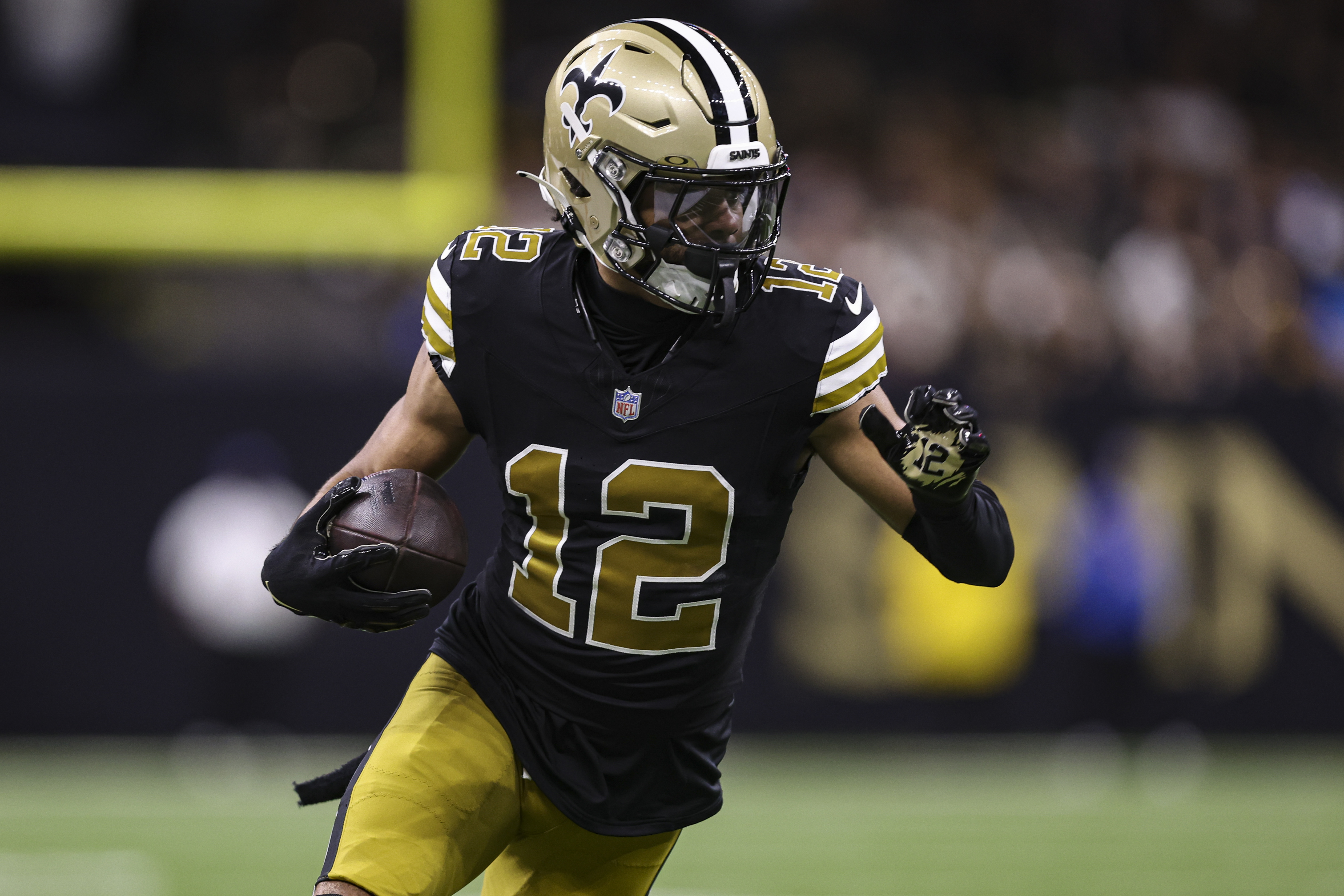 Chris Olave of the New Orleans Saints runs the ball during an NFL football game against the Carolina Panthers at Caesars Superdome on December 10, 2023 in New Orleans, LA.
