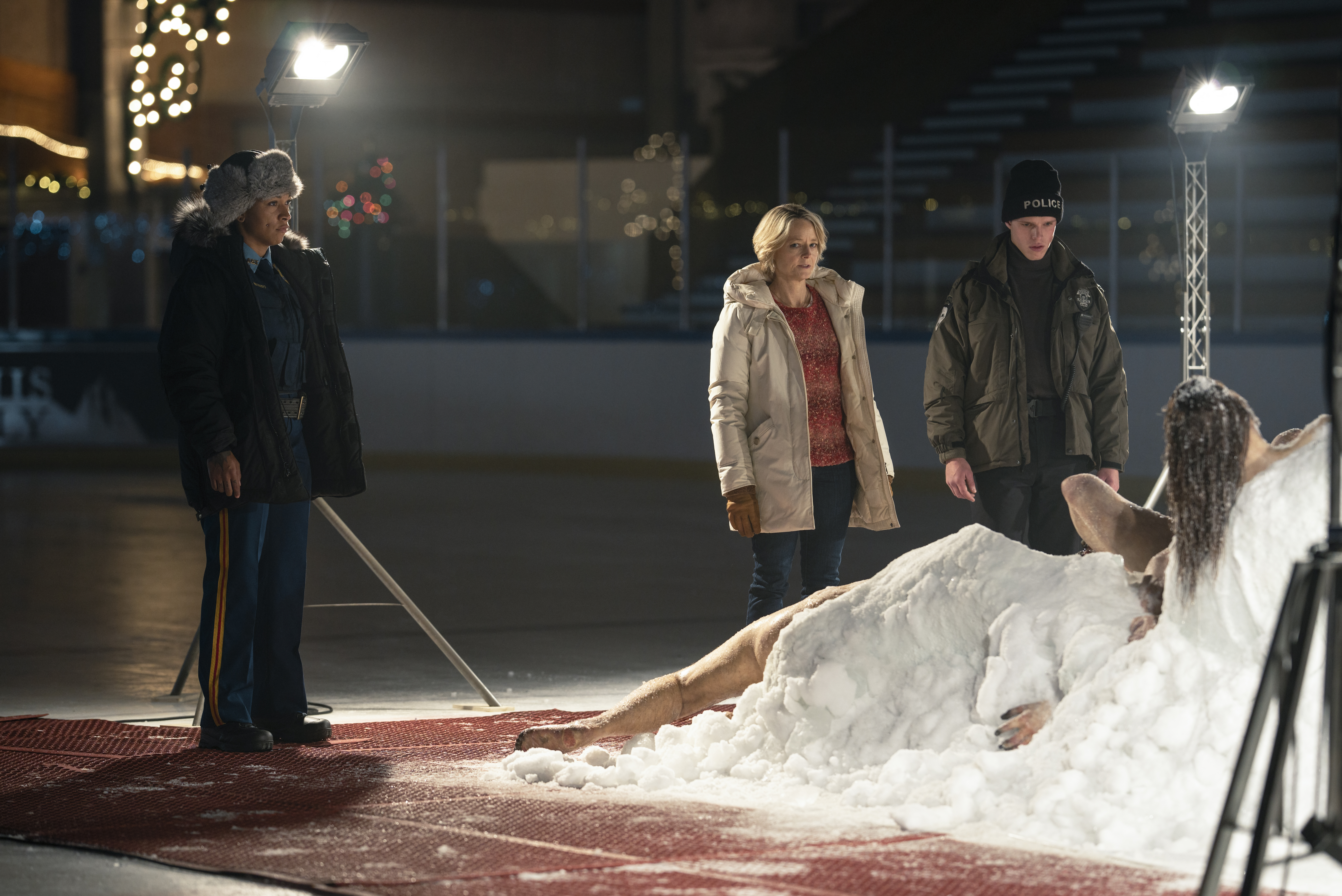 Navarro (Kali Reis), Danvers (Jodie Foster), and Pete (Finn Bennett) standing in front of the corpsicle, a frozen mass of several bodies, in True Detective: Night Country
