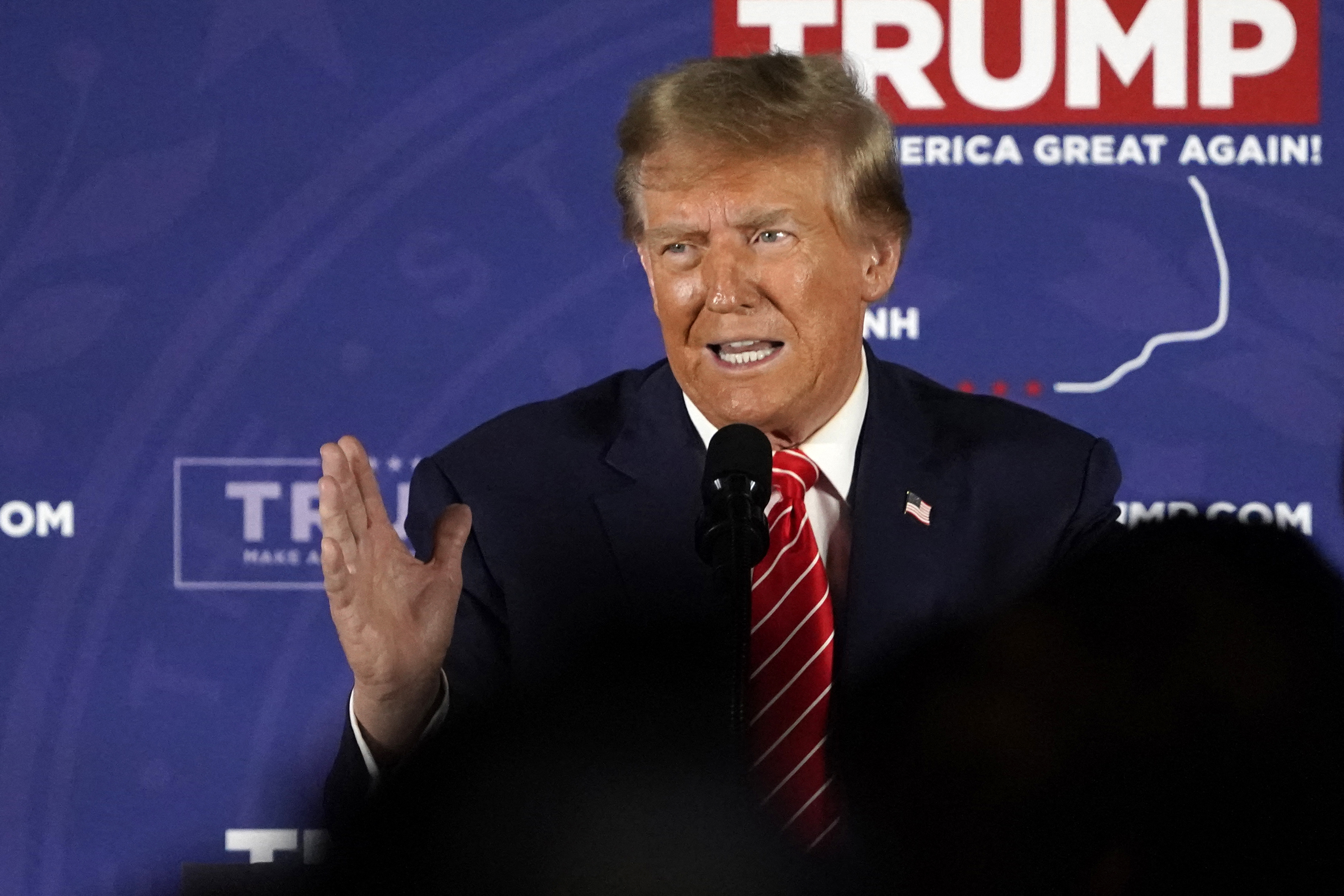 Trump puts out his right hand emphatically as he speaks during a rally on Monday in New Hampshire.