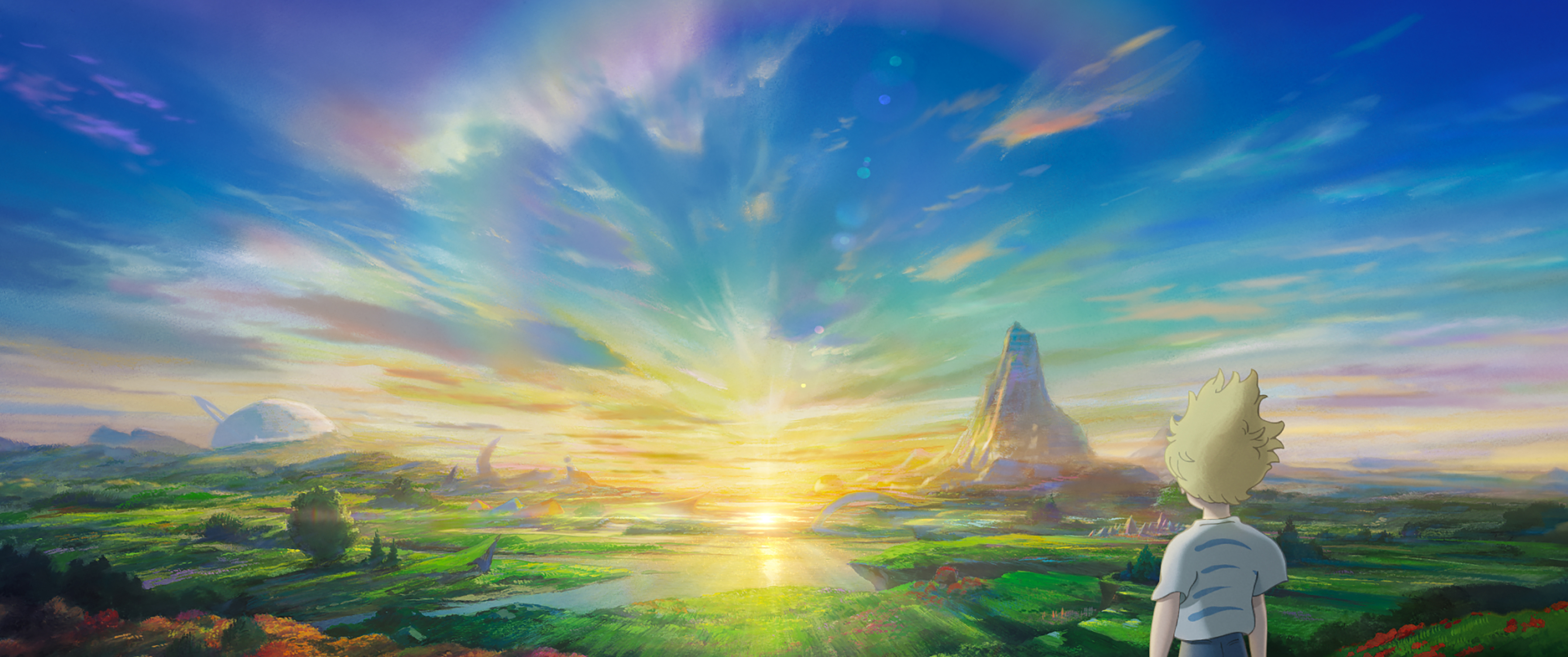 A tousle-haired blonde boy stands with his back to the camera in front of a gloriously bright and colorful sunrise (or sunset?) in a promotional image for Studio Ponoc’s animated movie The Imaginary