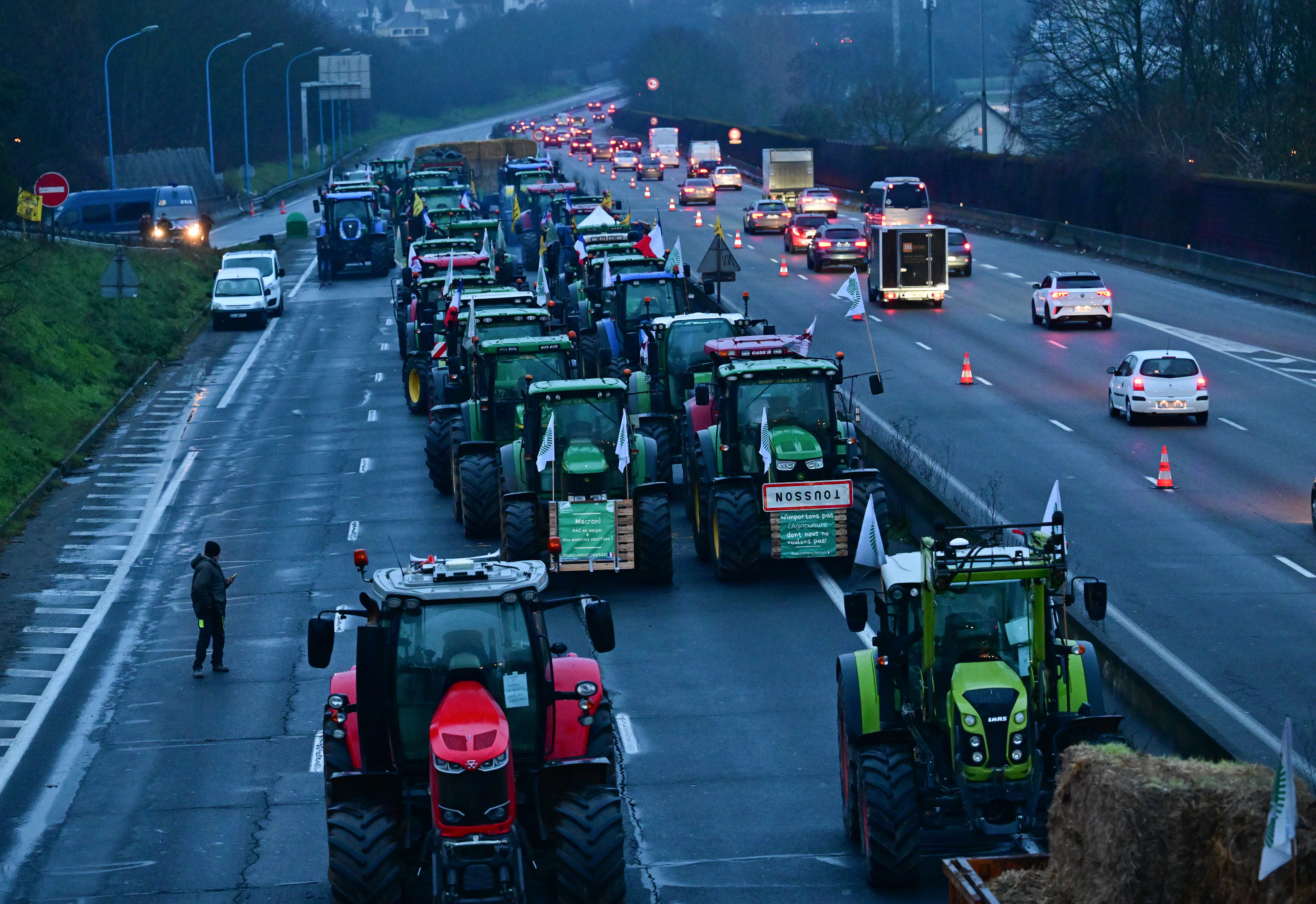 Farmers in agricultural machinery blockade a highway