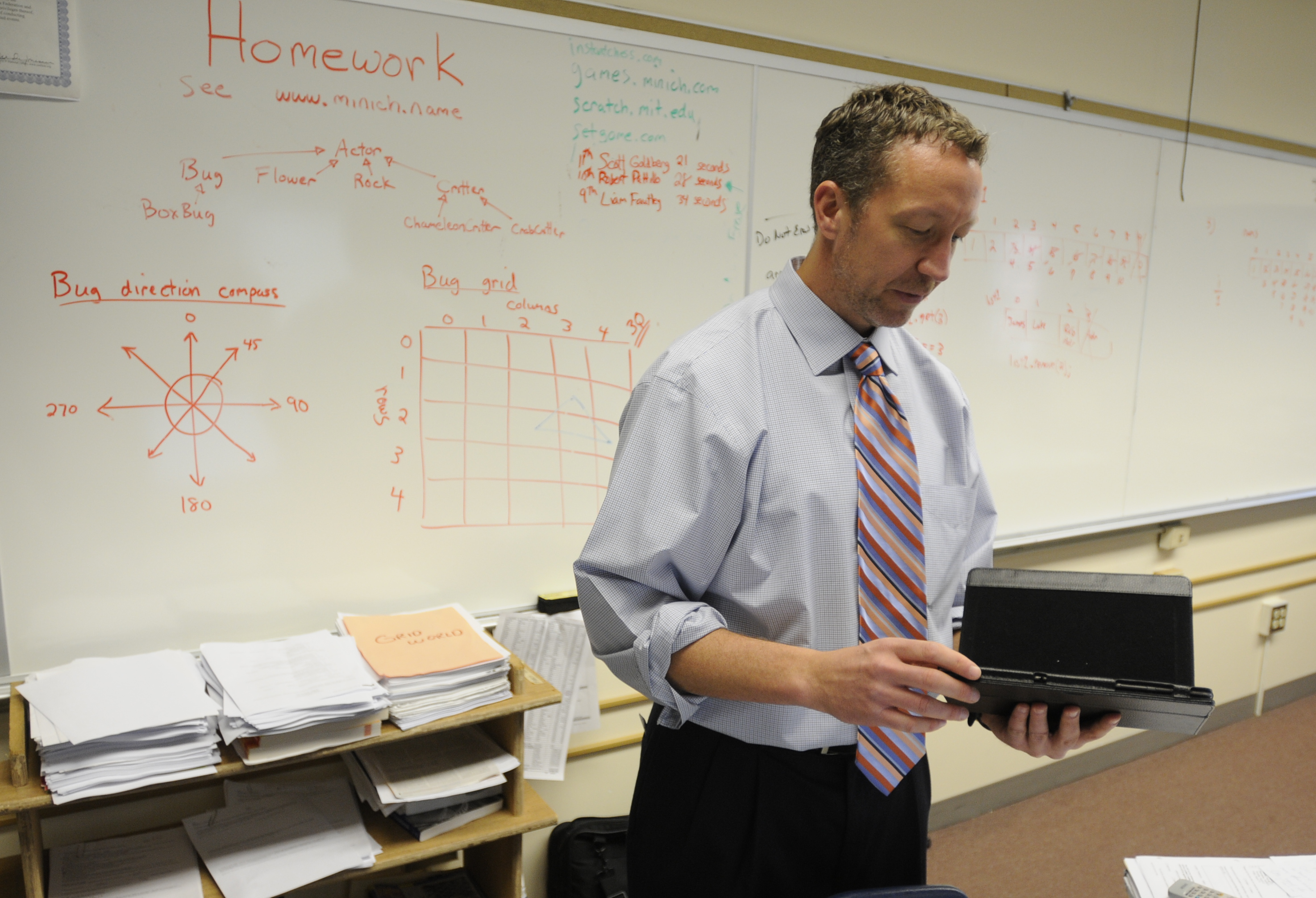 Teacher Curt Minich uses an Android tablet to check the students apps during the grading process.Wyomissing High School has had computer science courses for a number of years, but with changing technologies, students are learning new programming incl