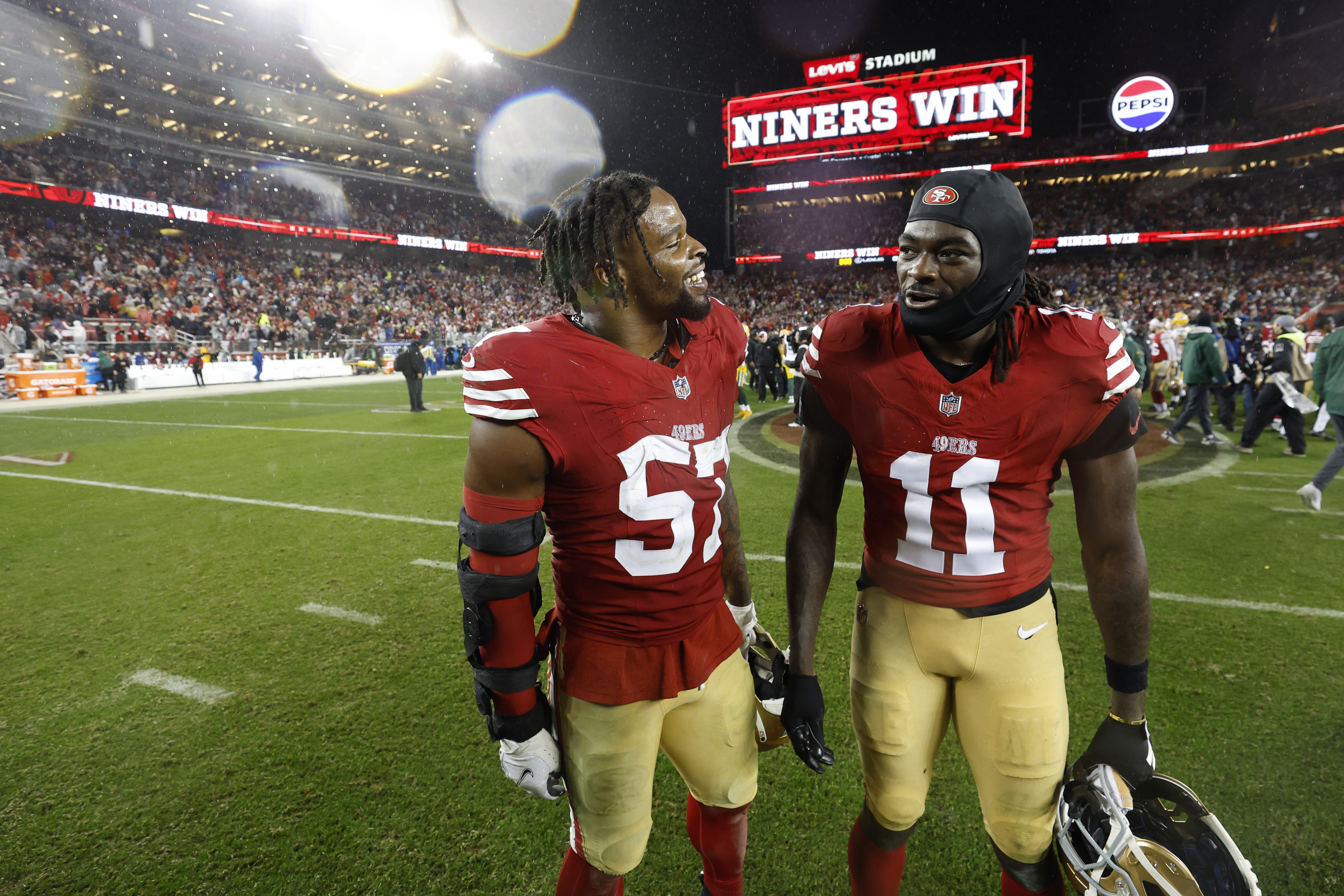 Dre Greenlaw #57 and Brandon Aiyuk #11 of the San Francisco 49ers leave the field after the 49ers defeated the Green Bay Packers 24-21 in the NFC Divisional Playoffs at Levi’s Stadium on January 20, 2024 in Santa Clara, California.