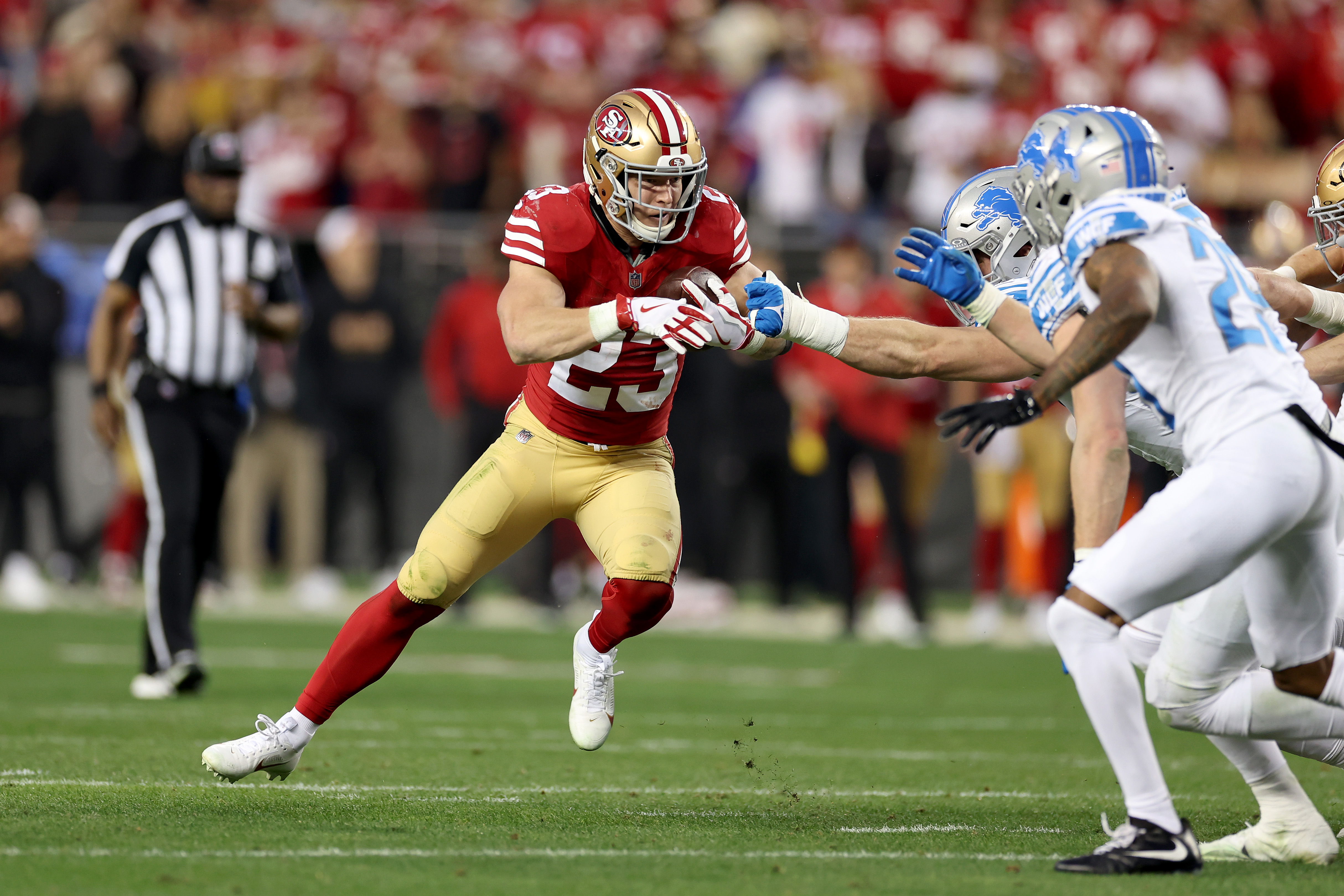 Christian McCaffrey #23 of the San Francisco 49ers runs with the ball against the Detroit Lions in the NFC Championship Game at Levi’s Stadium on January 28, 2024 in Santa Clara, California.