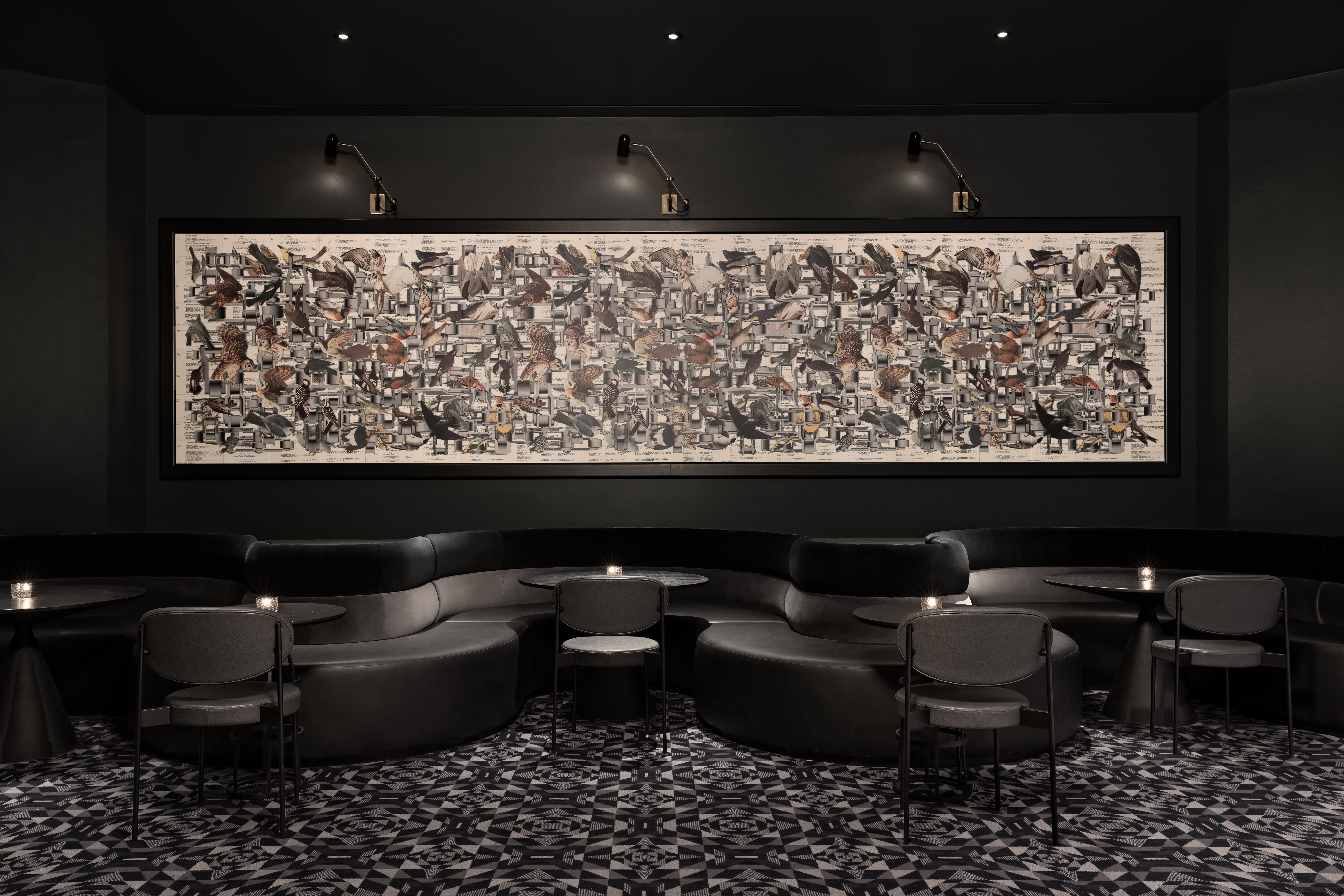 A huge painting overlooks black booths at Dark Bar in San Francisco