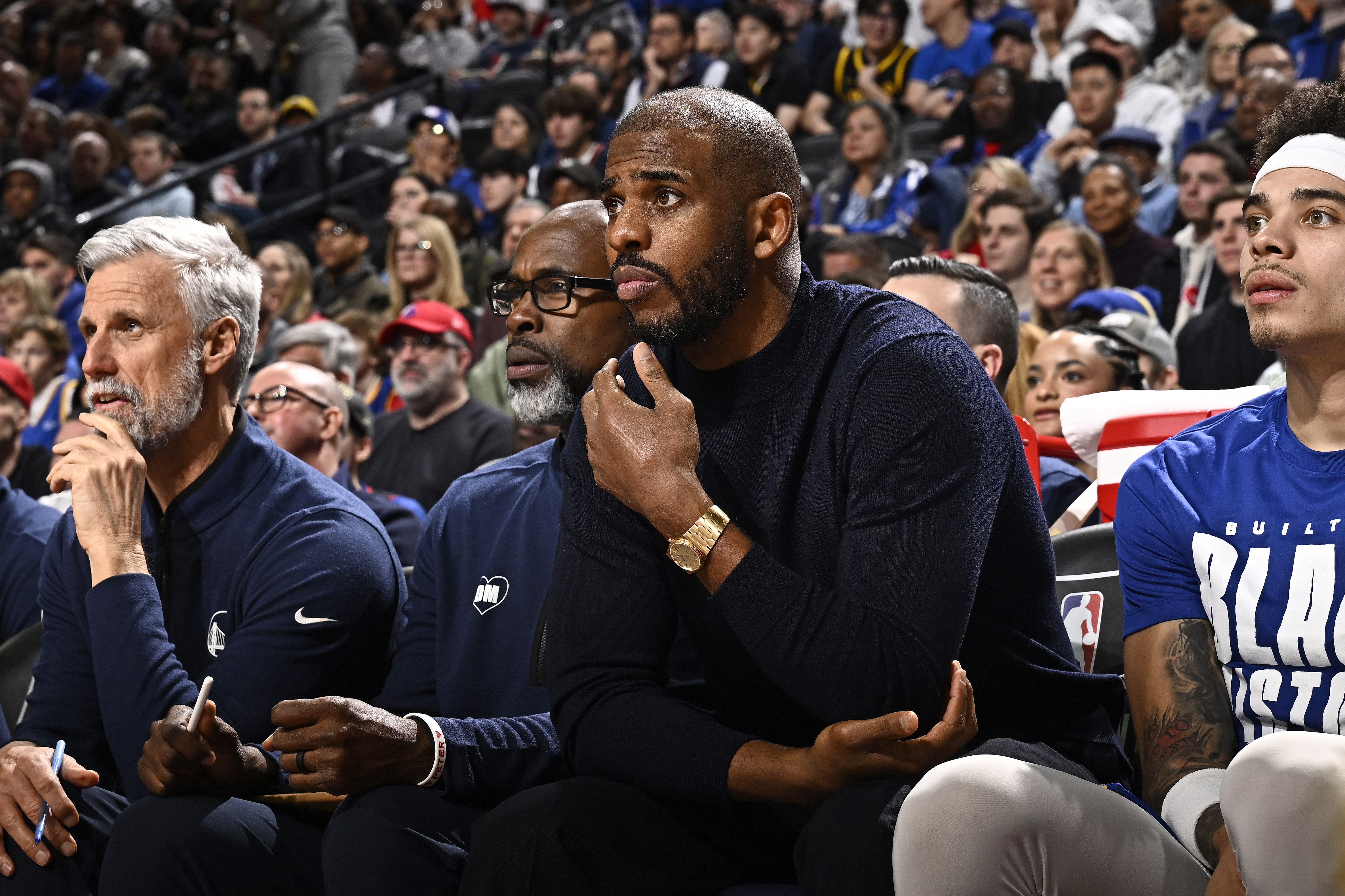 Chris Paul sitting on the Warriors bench. 