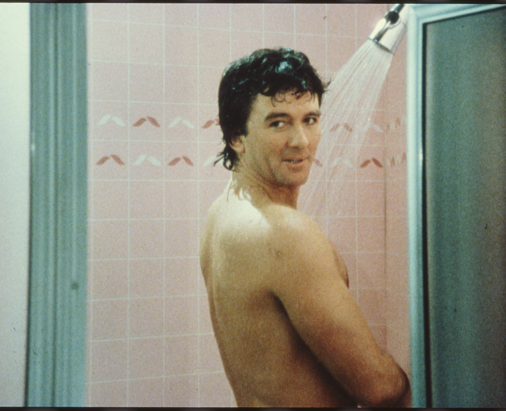 Patrick Duffy stands in a shower in Dallas.