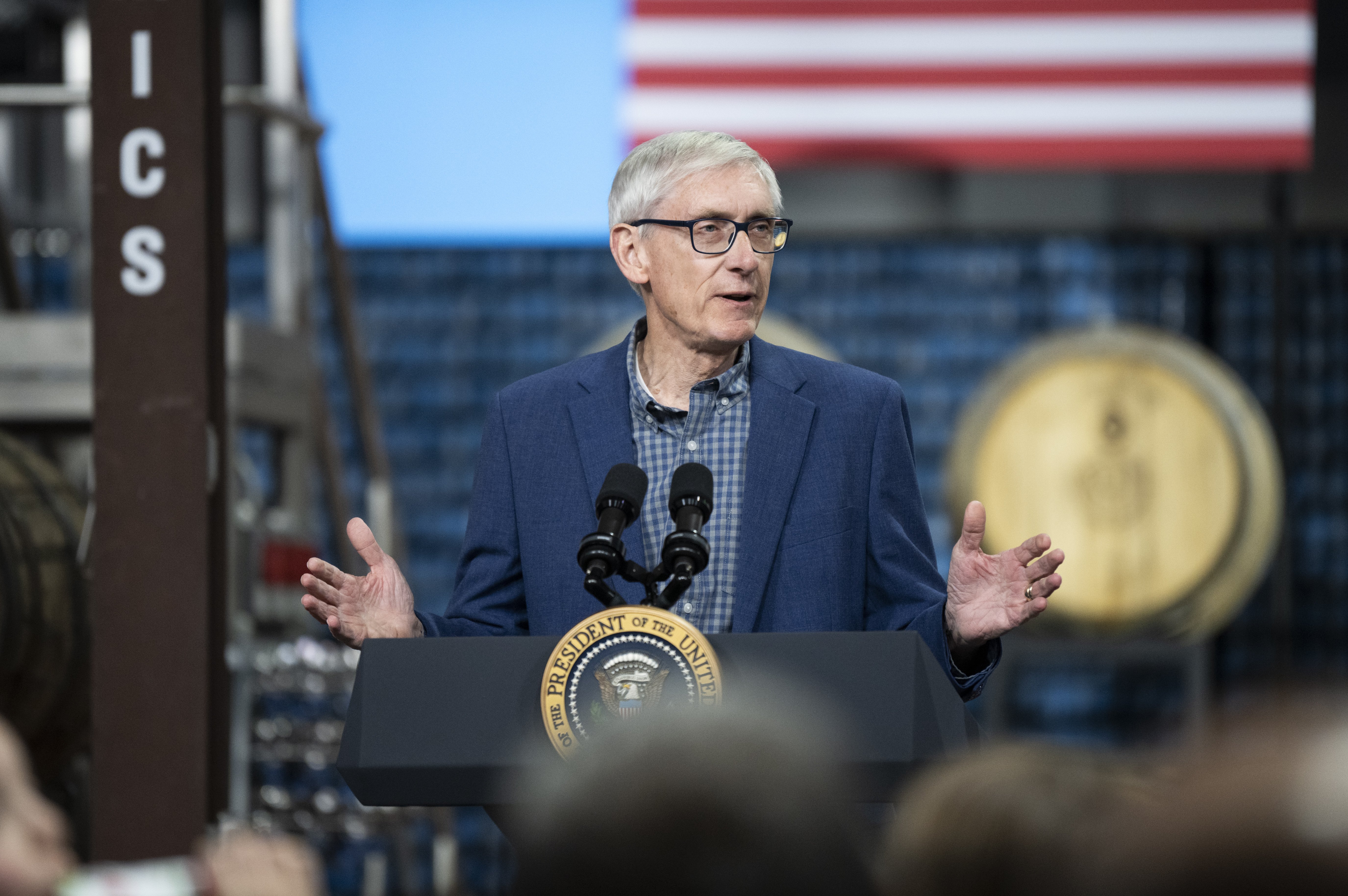 Tony Evers speaks at a lectern.