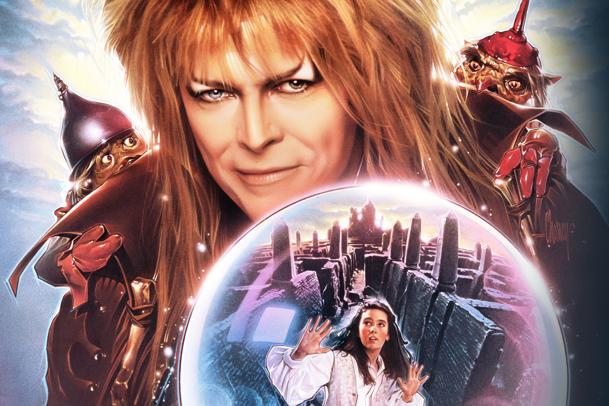 David Bowie’s Goblin King brandishes an orb containing a trapped Jennifer Connelly’s Sarah in key art for Labyrinth. 