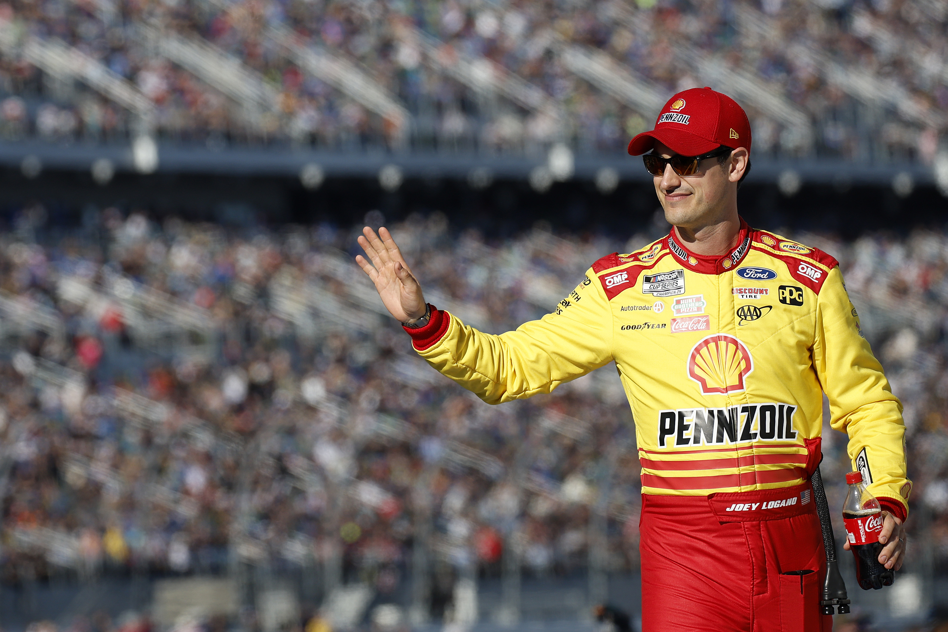 Joey Logano, driver of the #22 Shell Pennzoil Ford, waves to fans as he walks onstage during driver intros prior to the NASCAR Cup Series Daytona 500 at Daytona International Speedway on February 19, 2024 in Daytona Beach, Florida.