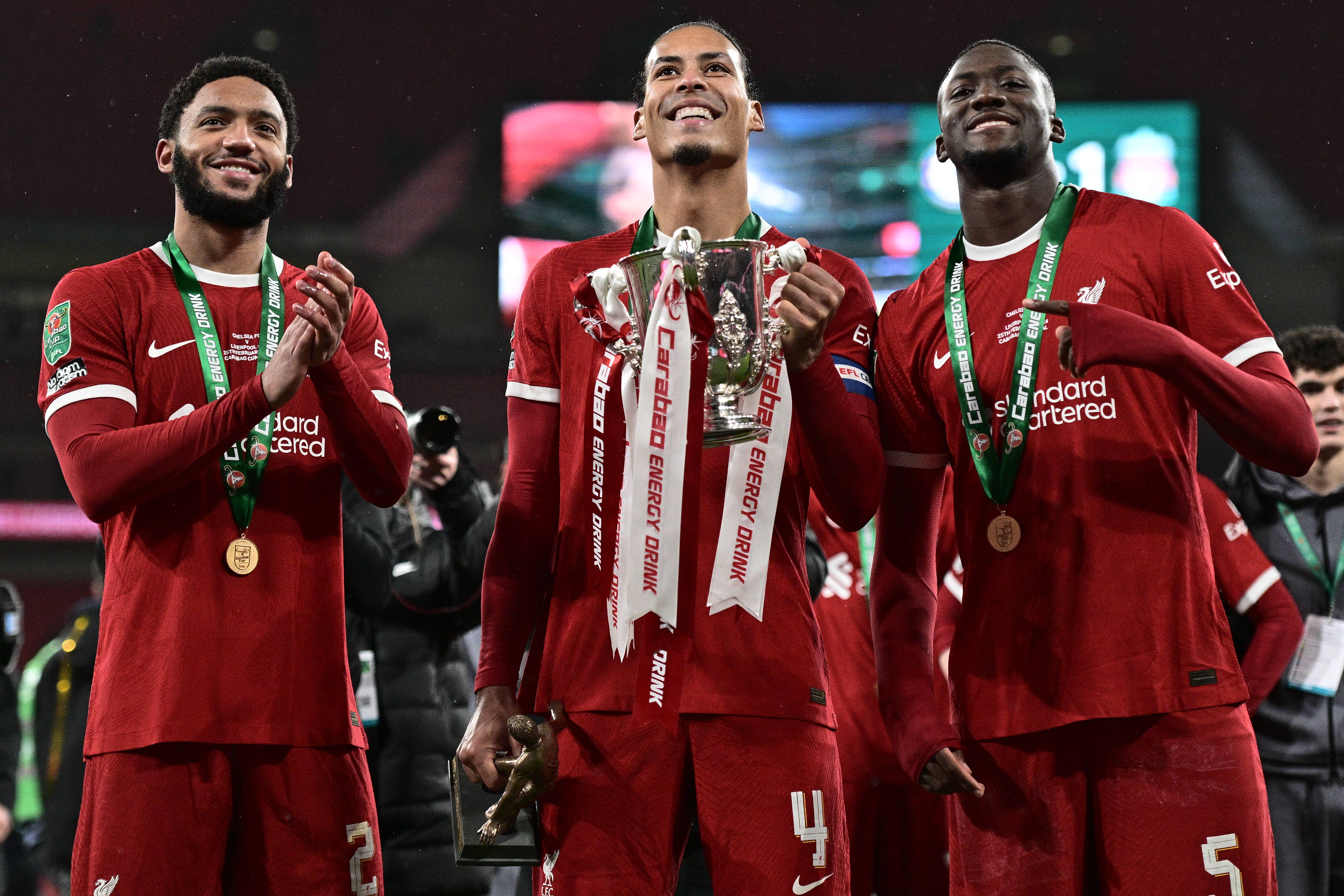 Joe Gomez, Virgil van Dijk, Ibrahima Konate celebrate with the trophy after winning the Carabao Cup after the Carabao Cup Final match between Chelsea and Liverpool at Wembley Stadium on February 25, 2024 in London, England.