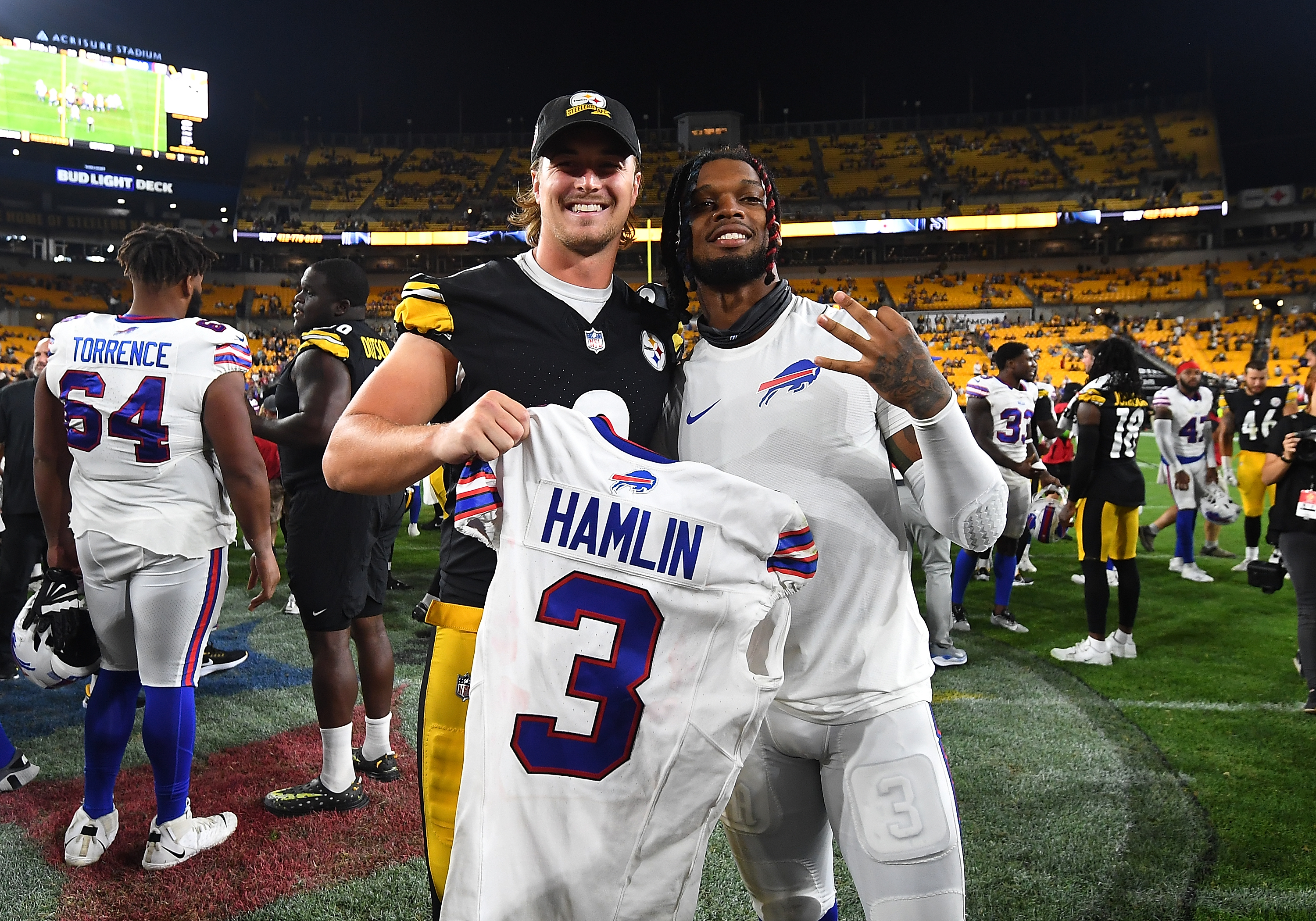 Kenny Pickett #8 of the Pittsburgh Steelers poses with Damar Hamlin #3 of the Buffalo Bills after a Pittsburgh Steelers 27-15 win during a preseason game at Acrisure Stadium on August 19, 2023 in Pittsburgh, Pennsylvania.