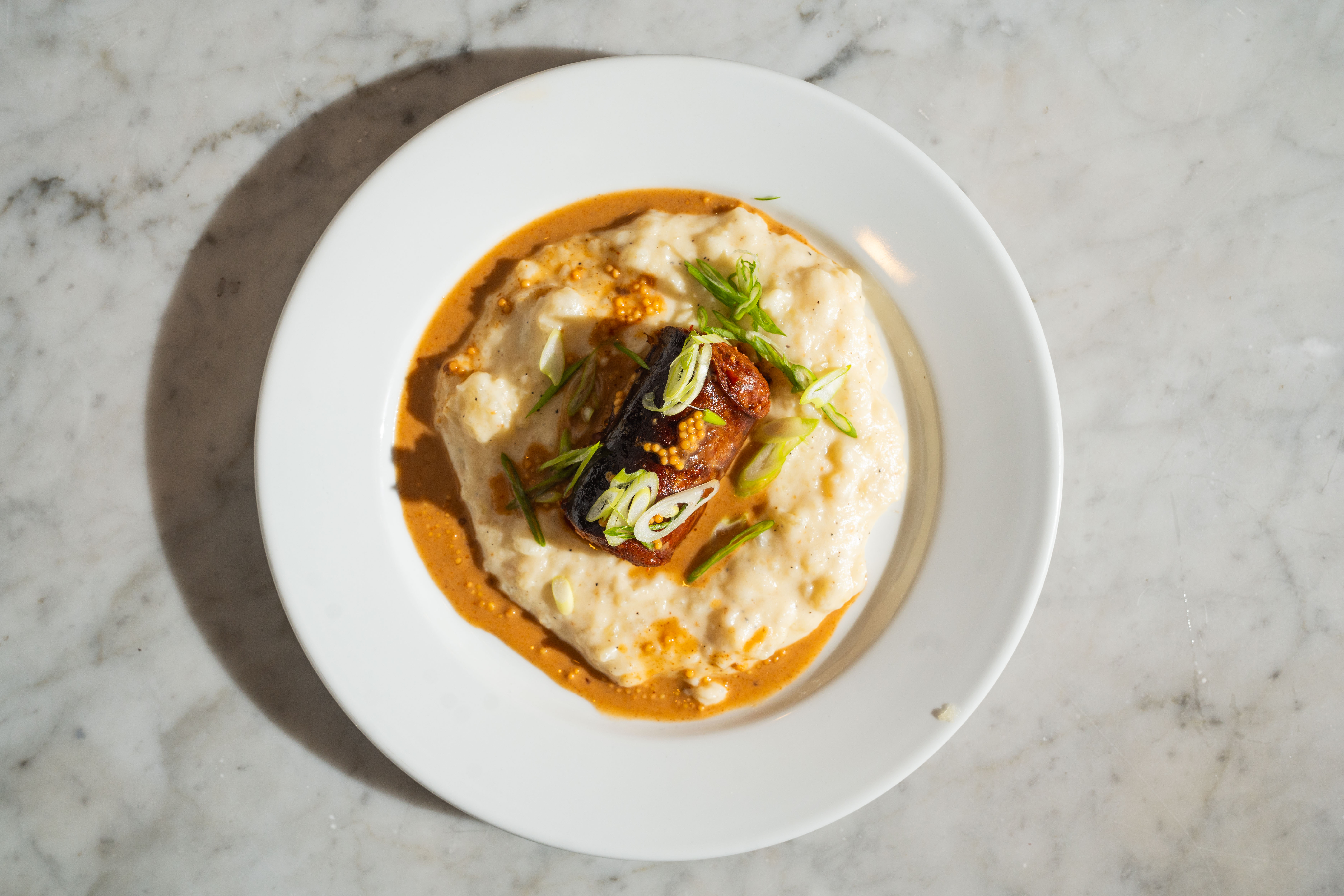 An image of a traditional southern American dish, likely fish and grits.